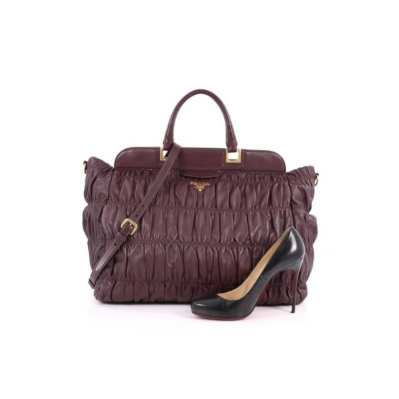 This authentic Prada Gaufre Convertible Frame Bag Nappa Leather Large is a beautifully and intricately designed bag perfect for everyday use. Crafted in gathered eggplant nappa leather, this frame bag features dual-rolled leather handles, protective
