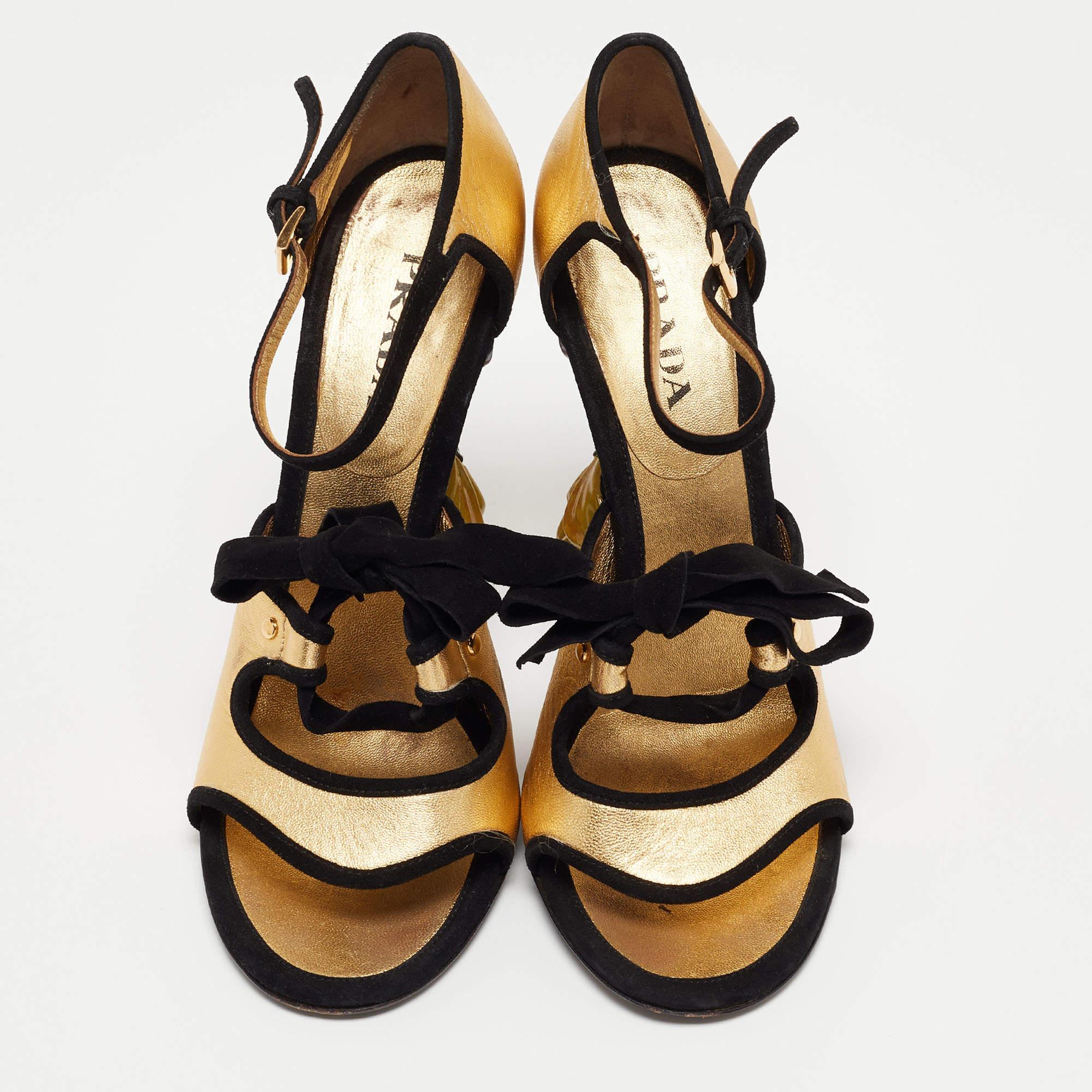 Continuing the delivery of feminine, luxe-chic footwear designs, Prada presents these beauties in gold and black. Constructed using leather and suede, the sanals are lifted on flower heels.

