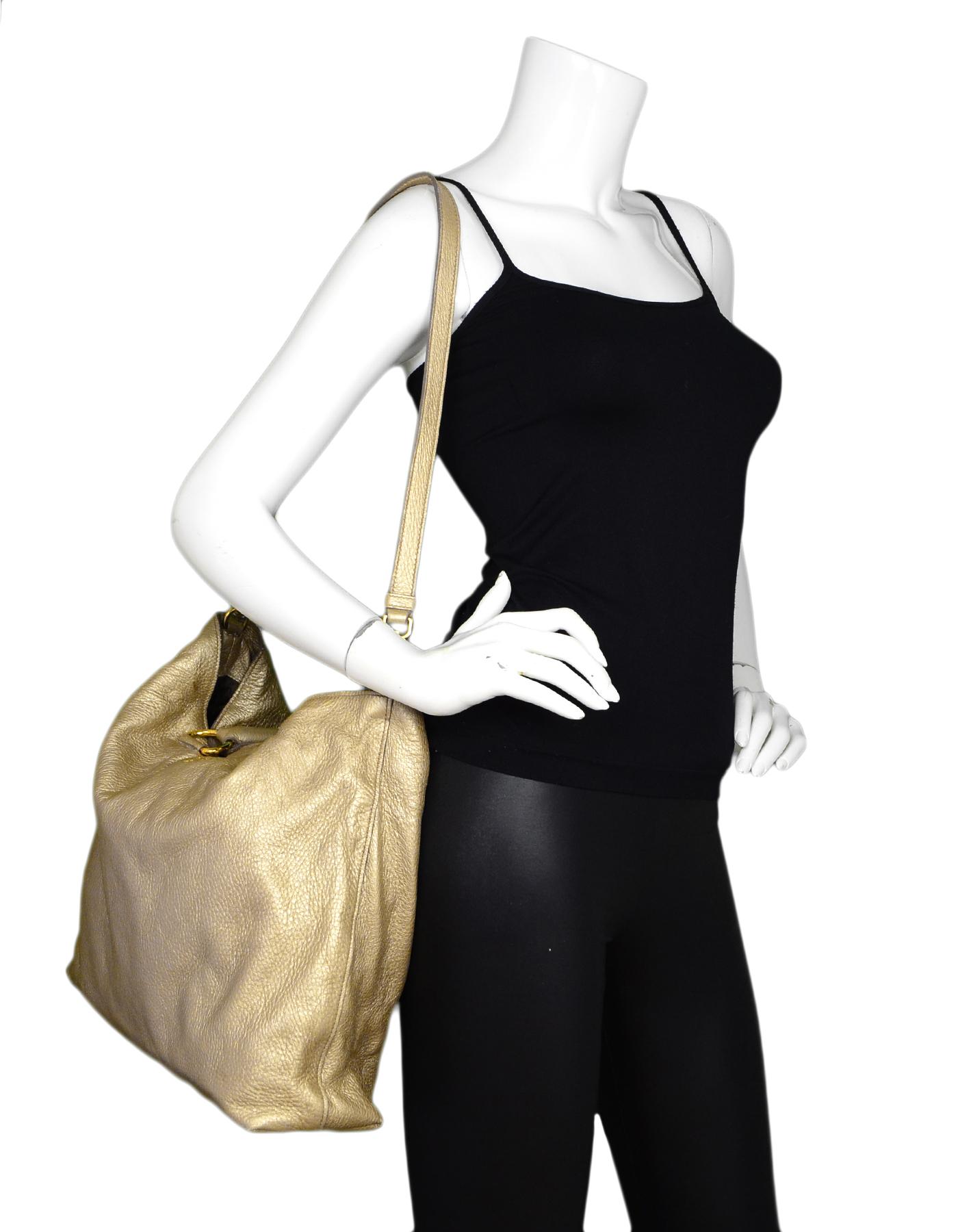 Prada Gold Pebbled Leather Tote Bag W/ Removable Strap

Made In: Italy
Color: Gold
Hardware: Goldtone
Materials: Pebbled leather, metal
Lining: Bronze/brown logo jacquard logo
Closure/Opening: Open top with magnetic tab in center
Exterior Pockets: