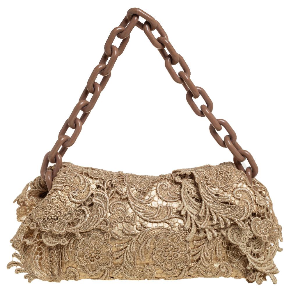 How chic and feminine this Prada bag looks! Crafted from Pizzo lace in a gold shade, this stunning bag is held from a chunky chain handle and finished off with a canvas & leather-lined interior.

Includes: Original Dustbag, Authenticity Card, Info