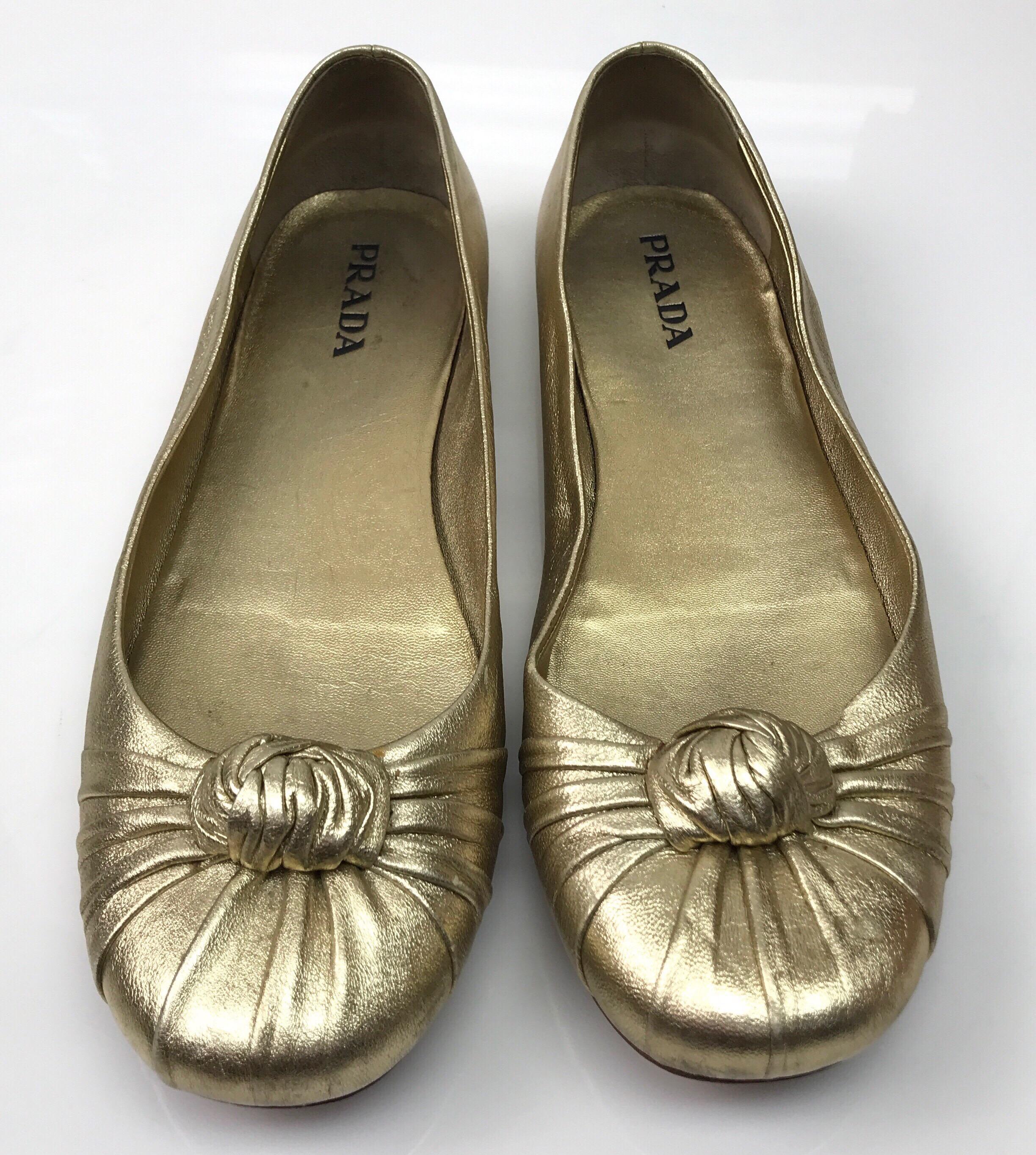 PRADA Gold Soft Leather Ballet Flat - 38. These adorable Prada ballet flats are in good condition. They show slight wear with marks and scratches on the leather and visible use on the bottom, as shown in pictures. They are gold throughout and have a