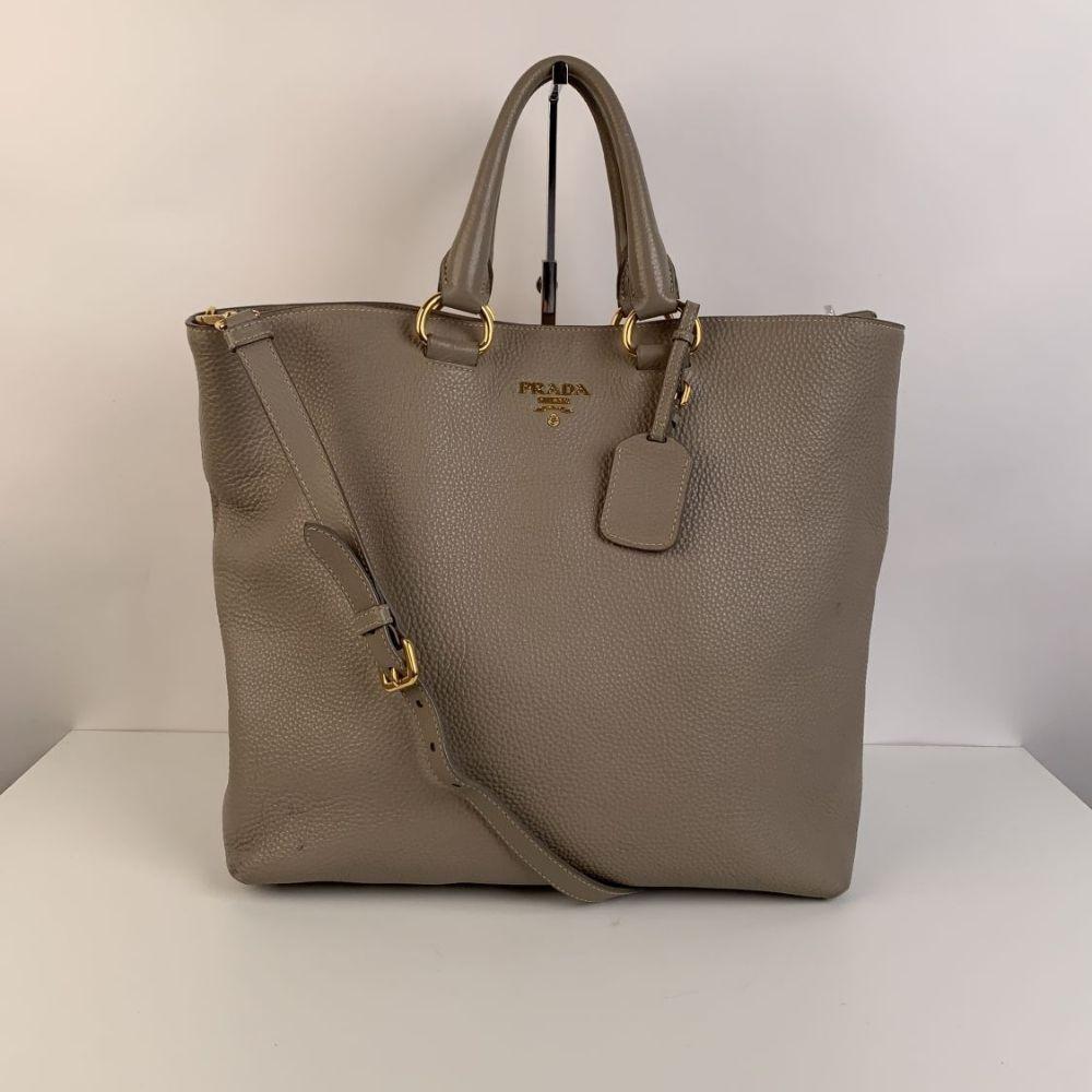 PRADA Vitello Daino leather tote bag. Mod. BN1713. Gray color (official Prada color is 'Pomice'). Simple and clean design, with a very roomy interior. It features a long removable and adjustable strap, double top handles and an ID tag. Center snap