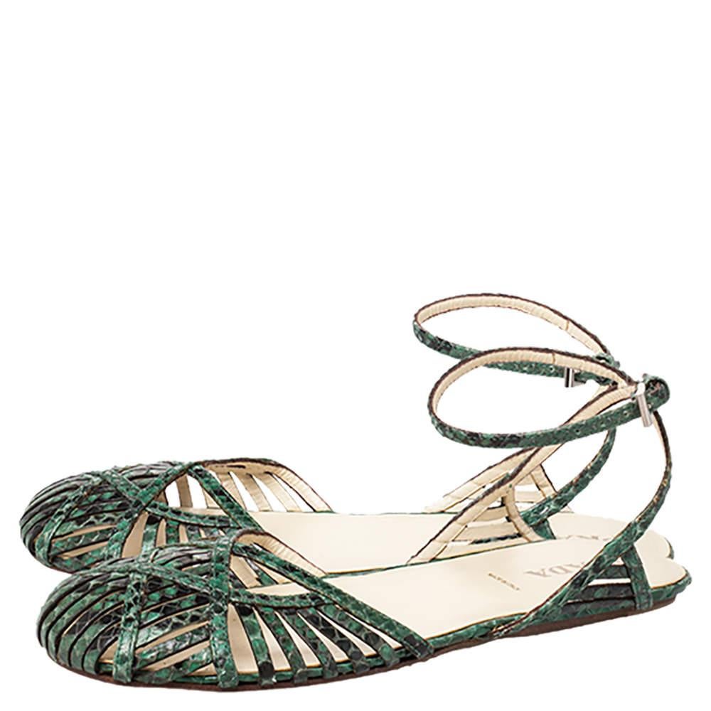 Gorgeous and contemporary, these Prada sandals will accentuate the beauty of your feet. Crafted from python skin in green and black shades, they are both comfortable and stylish. They feature covered strappy vamps and buckled ankle straps. The