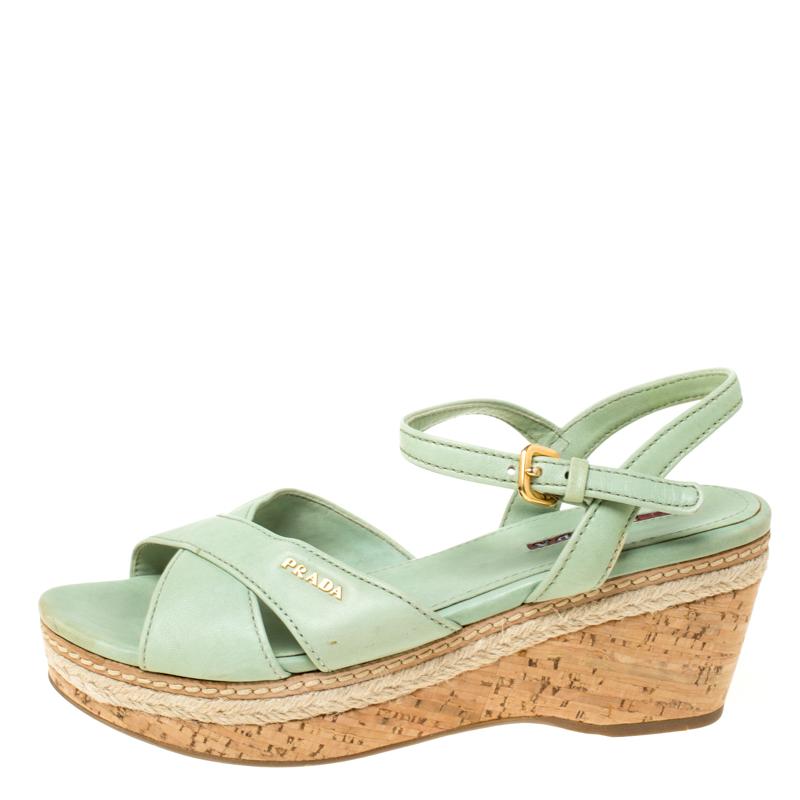 This pair of green espadrille sandals by Prada is lovely. They've been wonderfully crafted from leather and designed with ankle straps and cork wedges that have espadrille detailing. Complete with leather insoles, this pair is a