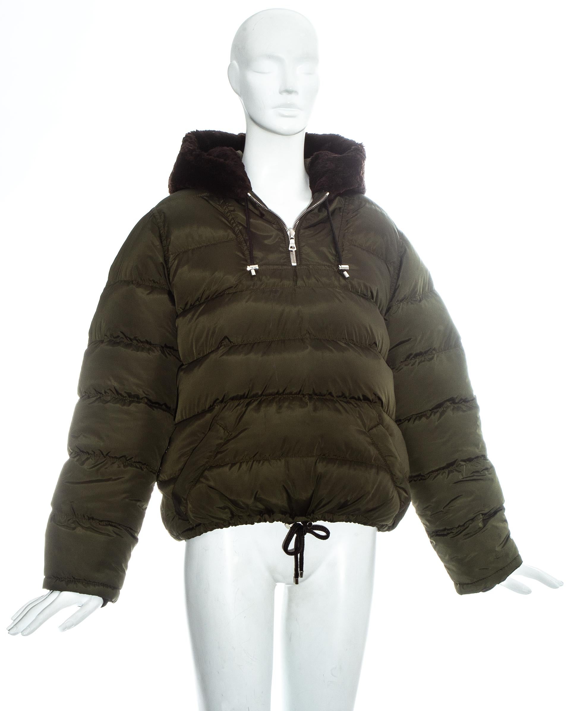 Prada green nylon duck down puffer sweater with beaver fur trim hood. Two zip front pockets, Drawstring toggle fastening on waist and hood, and built in elasticated belt. 

Fall-Winter 1993