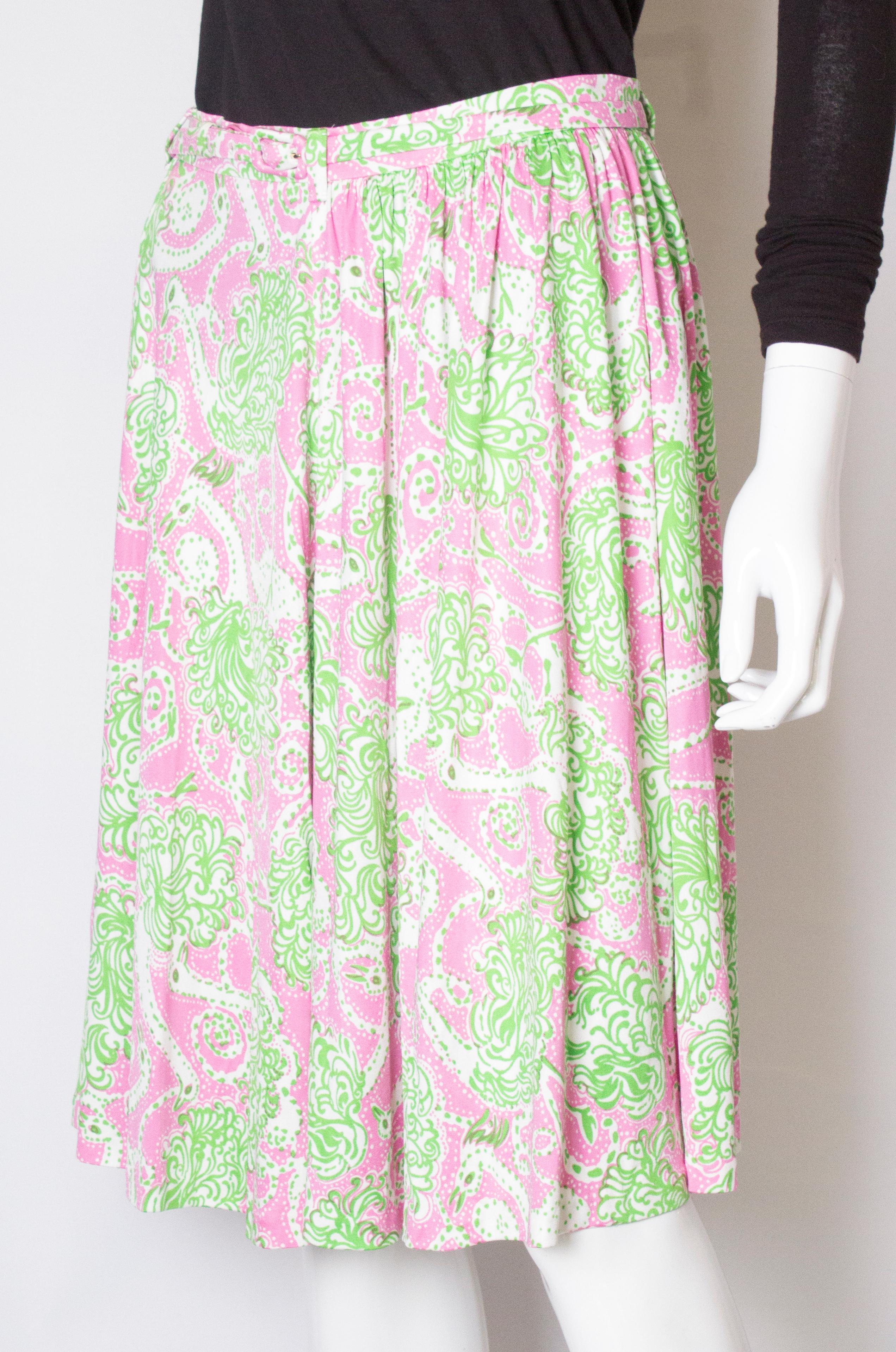 A super skirt for Spring. In a super soft silk jersey in a colourful combination of pink, green and white, the skirt has a central back zip and a self fabric belt.