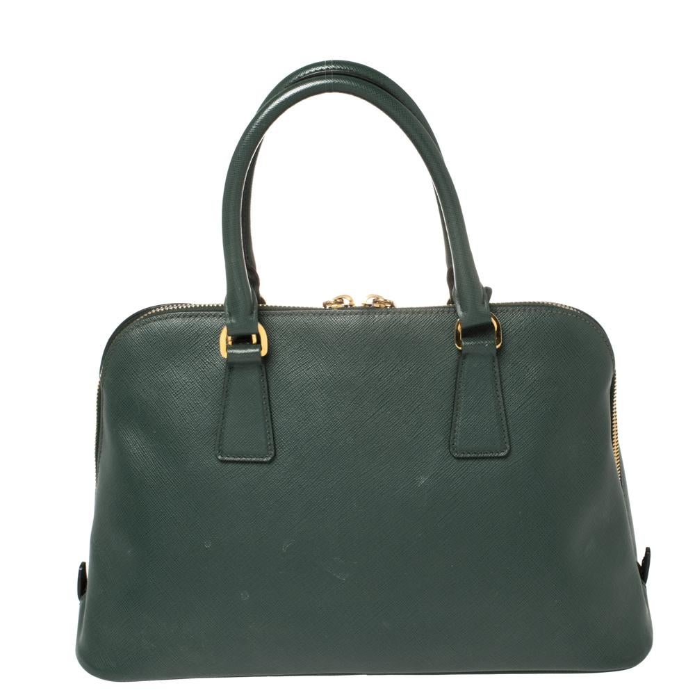 This stunning Promenade satchel is high on appeal and style. Dazzling in a classy green shade, the bag is crafted from leather and features two rolled handles. The zip closure leads way to a fabric interior with enough space for your essentials and