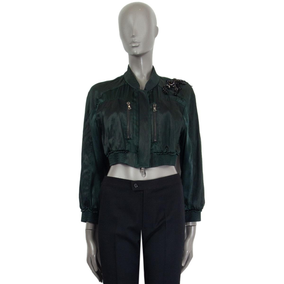 Prada cropped satin bomber jacket in forest green cupro (100%) silk (63%) cotton (33%) other fibers (4%) with a shoulder Scorpion embellishment, two slit pockets, two zipped pockets and ribbed elastic cuffs and hem. Closes with a zipper in the