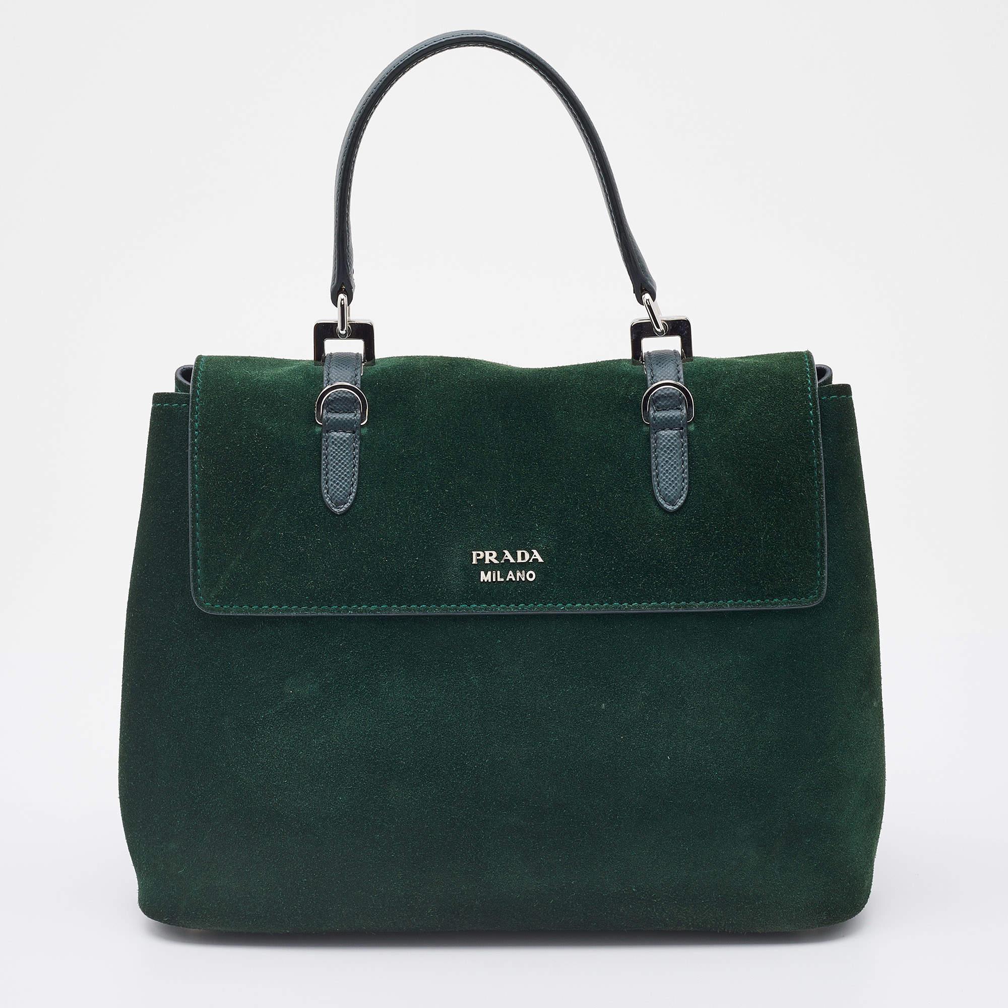 This stylish bag from Prada has been crafted from suede. The top opens to a capacious interior that can easily hold your everyday essentials. The bag is finished with silver-tone hardware and a top handle.

Includes: Original Dustbag, Detachable
