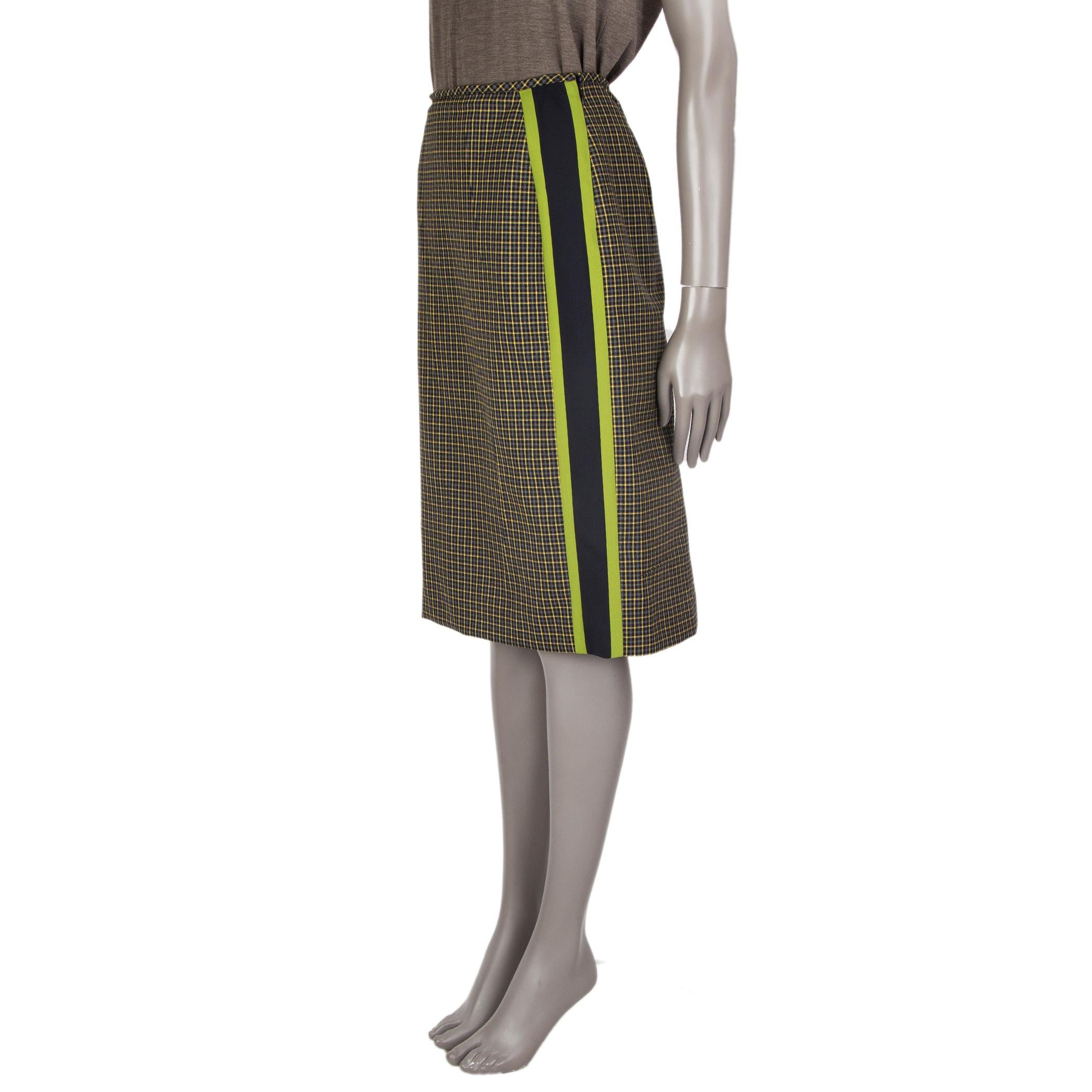 Prada plaid midi skirt in midnight blue, grey, chartreuse, yellow wool (100%). With a straight fit, slit on the back and detailed with panels on the side in midnight-blue and chartreuse. Closes with a zipper on the lefts side. Lining viscose (100%).