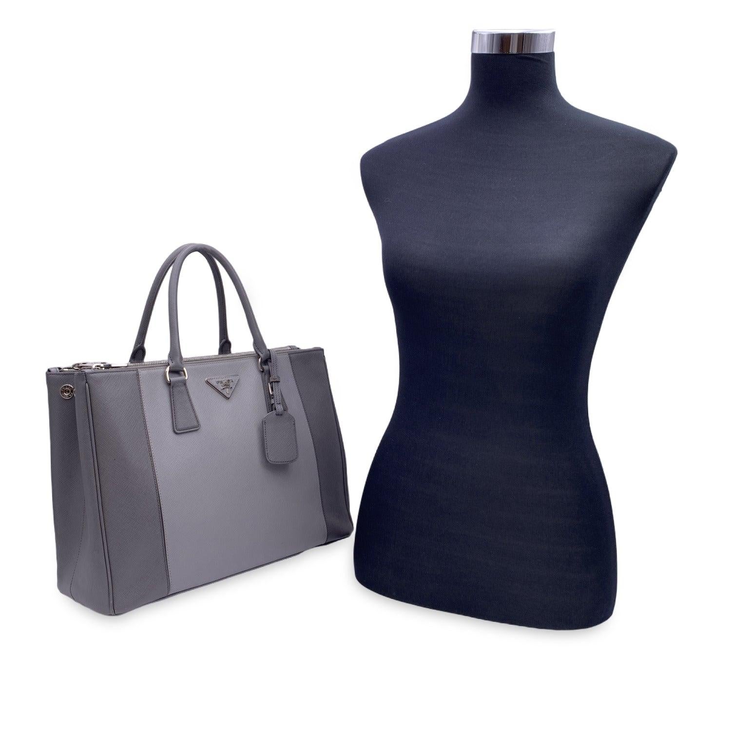 This beautiful Bag will come with a Certificate of Authenticity provided by Entrupy. The certificate will be provided at no further cost Stunning PRADA top handles bag/handbag mod. 'Galleria', designed in different shades of grey Saffiano leather