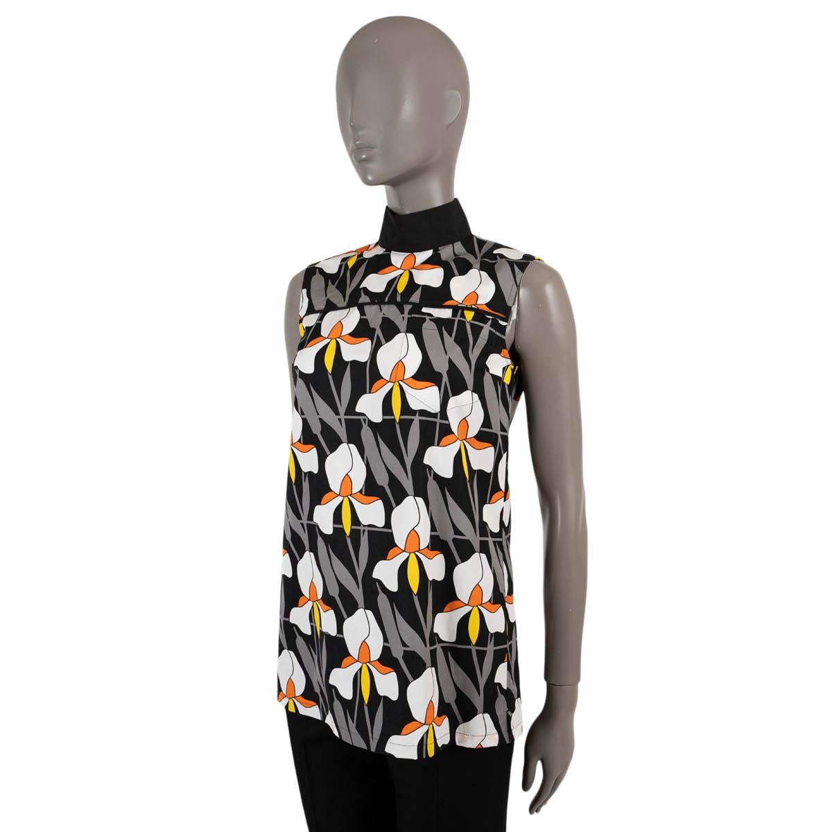 100% authentic Prada sleeveless blouse in black, grey, white, orange and yellow floral-print cotton (100%). Features a mock neck and a chest pocket. Opens with buttons in the back and is unlined. Has been worn and is in excellent condition. 

2020