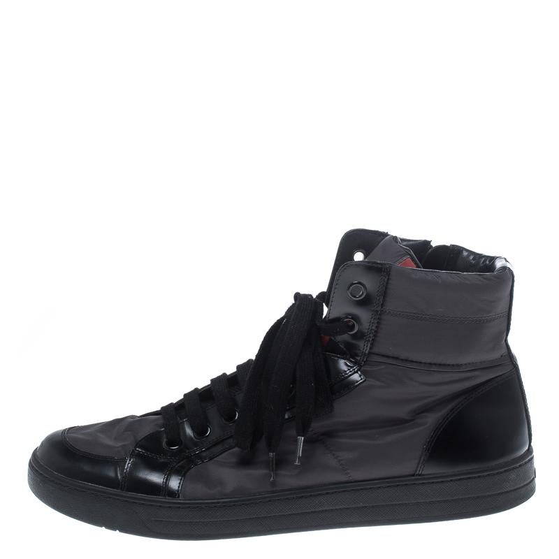 Flaunt your high-style with these high top sneakers from Prada. They've been carefully crafted from grey nylon and trimmed with black leather. Complete with lace-up vamps, the brand logo on the tongue, and leather insoles; you are sure to receive