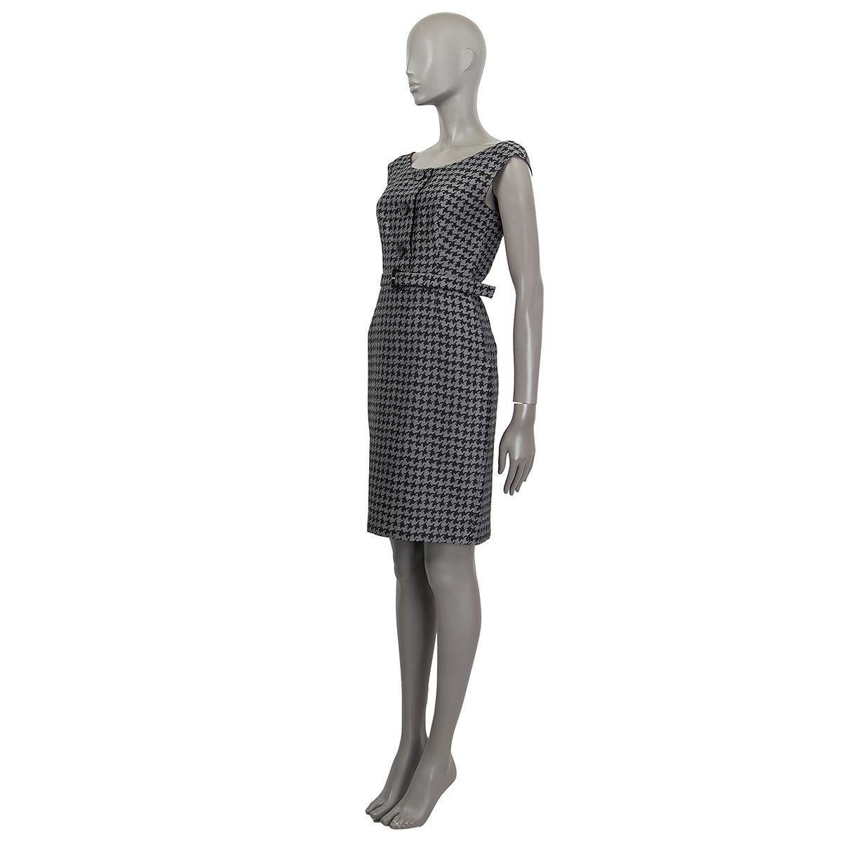 100% authentic Prada houdstooth sleeveless belted dress in grey and black wool (with 14% silk) with three black bottons. Opens with a concealed zipper in the back. Lined in viscose (66%) and silk (34%). Has been worn and with a minor chip on the top