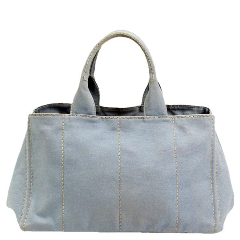This canvas tote bag from Prada is perfect for everyday casual use. True to its nature, the brand keeps it stylish and the bag has brand lettering embossed on the front panel. It has a rich grey colour and a spacious main compartment to easily hold