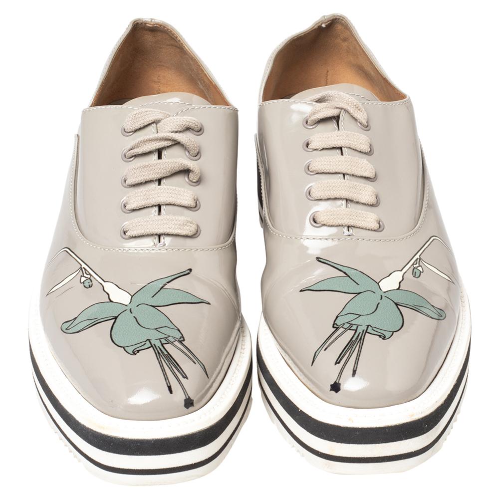 Prada ensures a statement look with this stunning design! The leather oxford shoes are well-crafted and they are beautified with lace-ups and floral print detailing. Comfortable insoles and chunky platforms complete this must-have pair!


