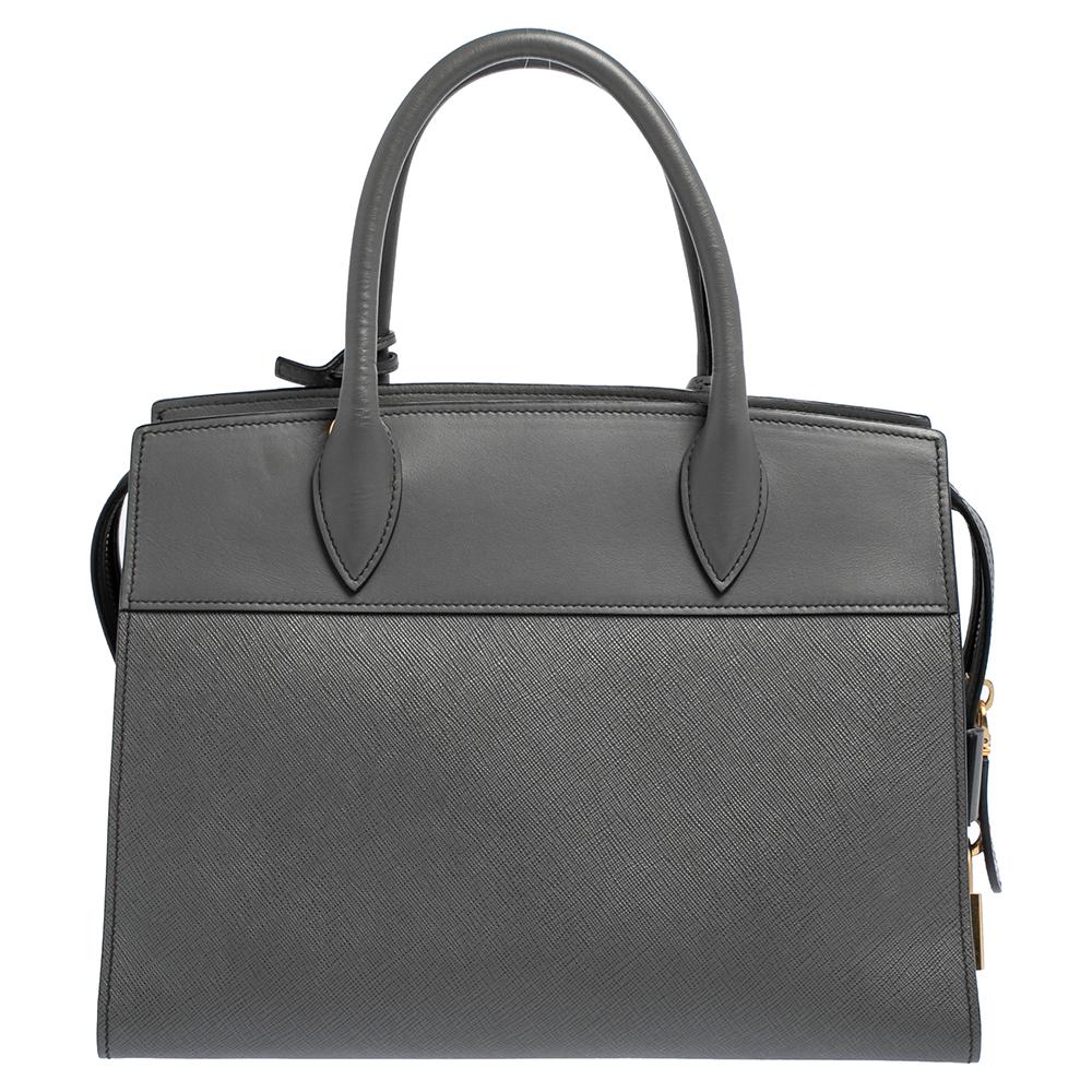 This Esplanade tote by Prada will be a fine companion to a woman who is heading to work or brunch. This leather bag is brilliantly fashioned and spaciously sized. The quality leather used for the bag assures durability while the brand name on the