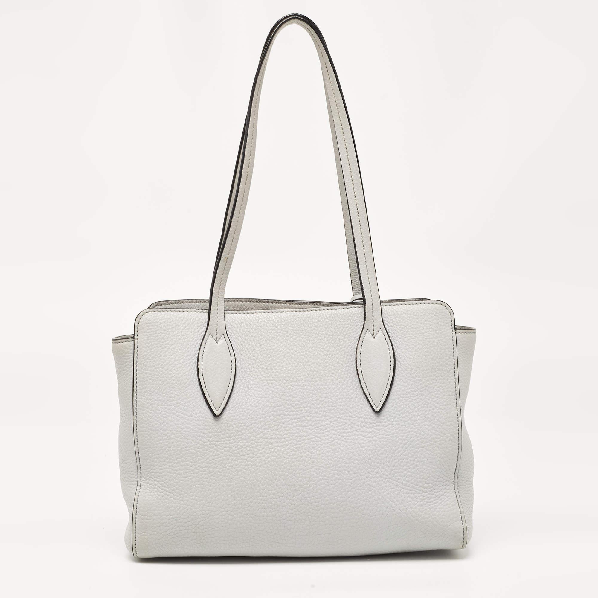 A classic handbag comes with the promise of enduring appeal, boosting your style time and again. This Prada grey tote is one such creation. It’s a fine purchase.

