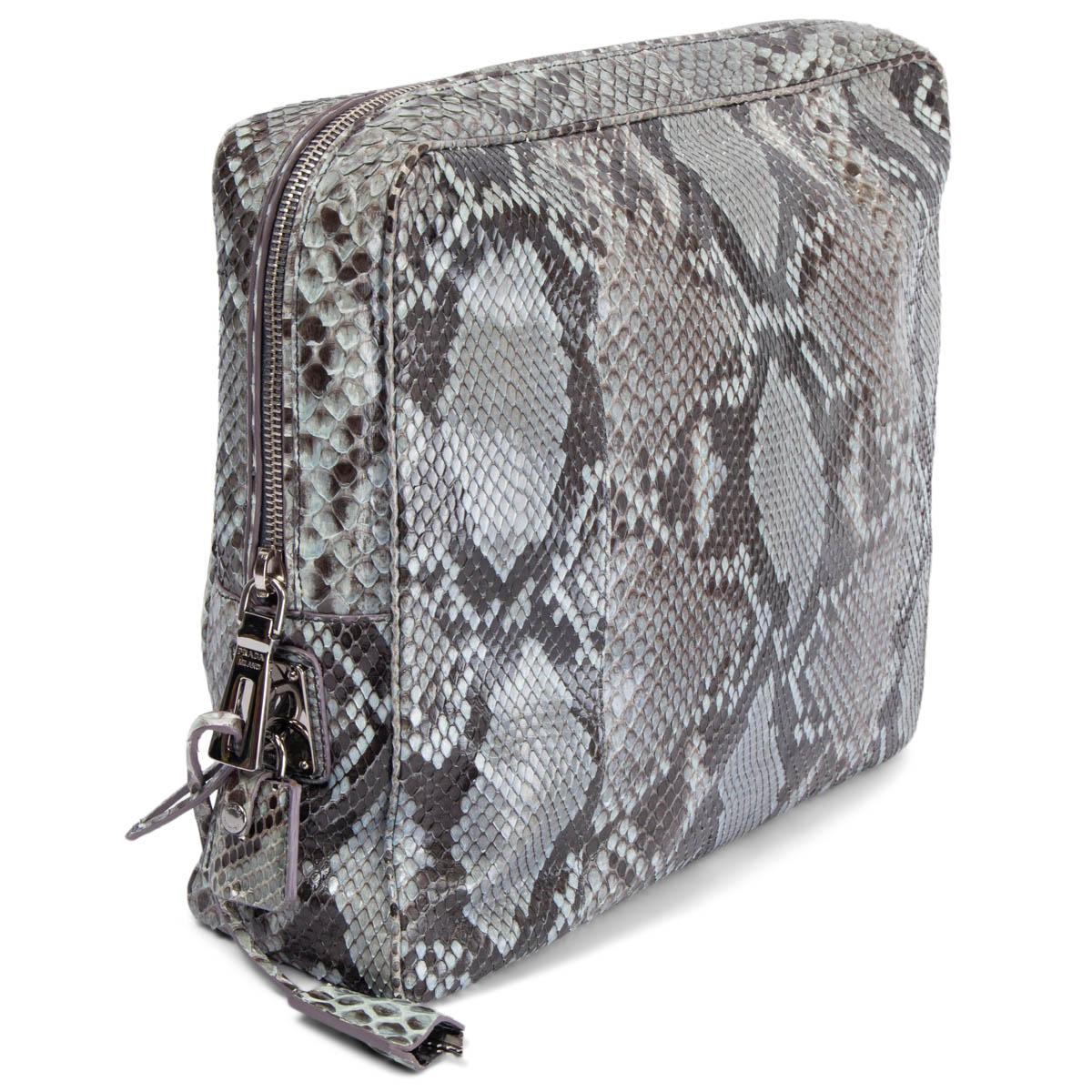 100% authentic Prada large clutch bag in grey and black python featuring silver-tone hardware. Opens with a zipper on top and is lined in nude smooth lambskin with one big zipper pocket against the back and two open pockets against the front. Has
