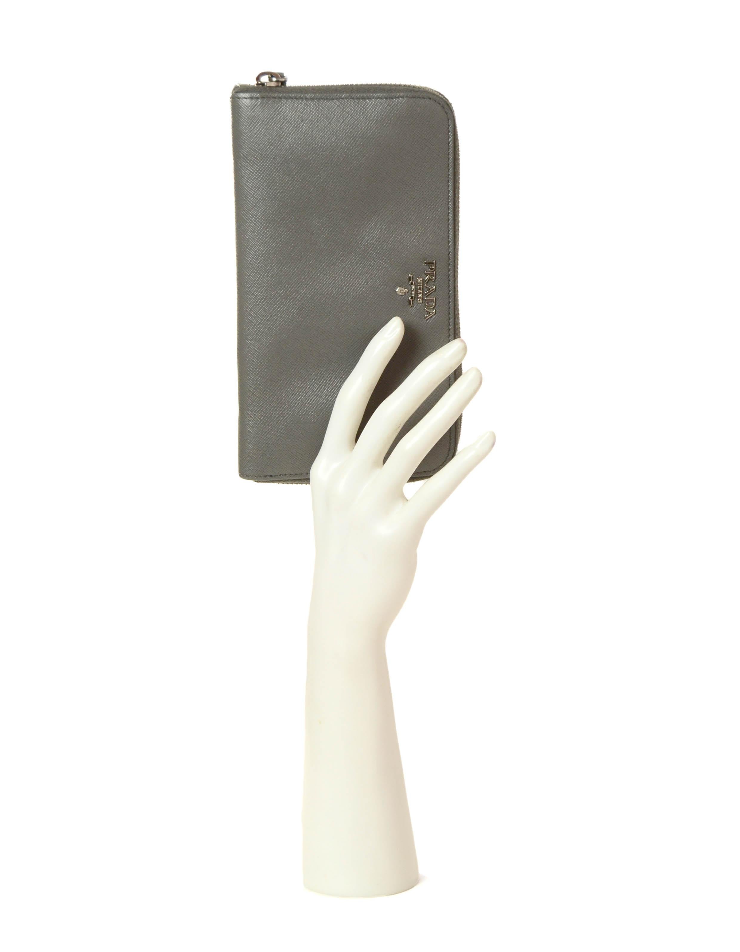 Prada Grey Saffiano Leather Zip Around Wallet

Made In: Italy
Color: Grey
Hardware: Silvertone
Materials: Saffiano leather
Lining: Saffiano leather & nylon
Closure/Opening: Zip around
Interior Pockets: 8 credit card slots, 1 middle zipper pocket,