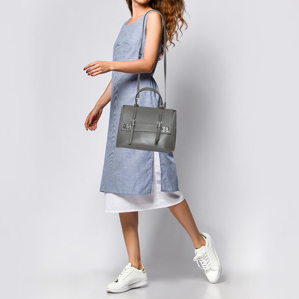 Timelessly elegant and stylish, Prada's collections capture the effortless, nonchalant finesse of the modern woman. The bag is crafted from Saffiano Lux leather and features buckle detailing on the flap. The interior is leather-lined and spacious