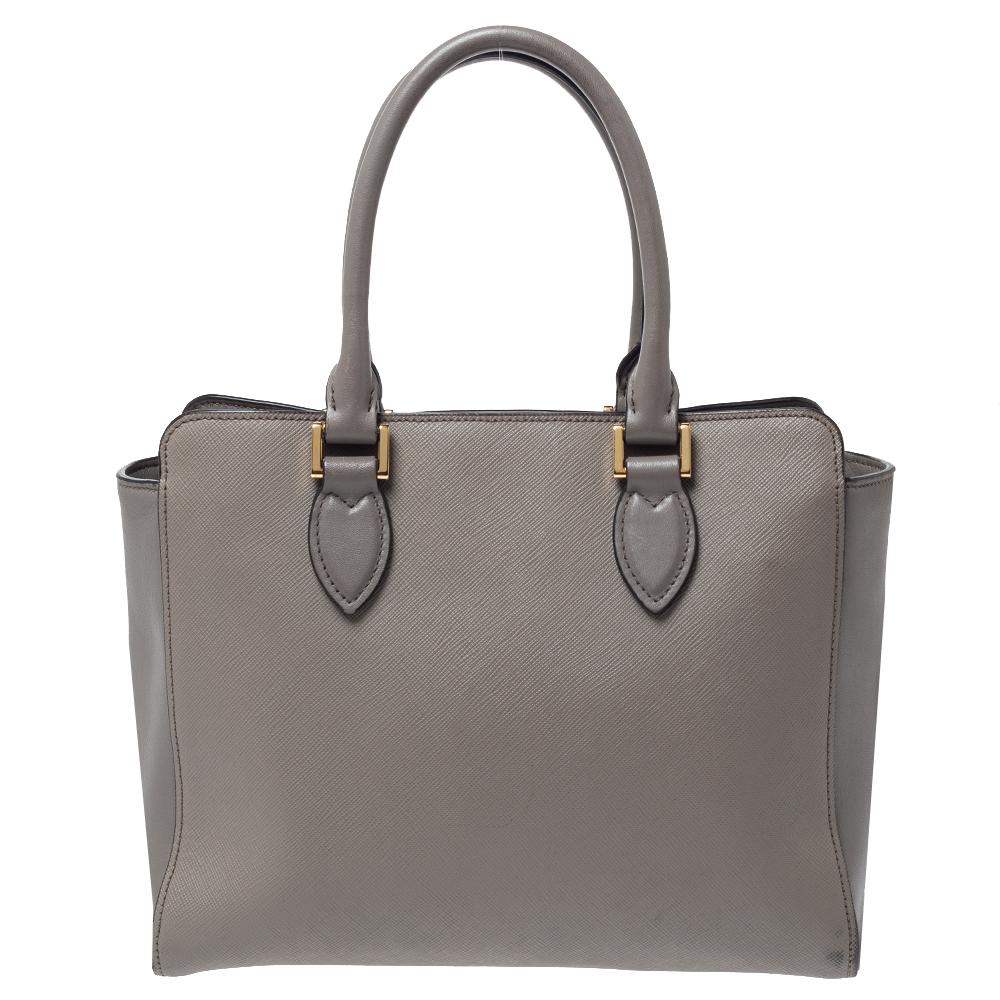 This finely designed bag by Prada will capture your stylish side with ease. This Saffiano Lux leather creation is a first-class pick for all your essentials. This nylon interior can easily accommodate all your essentials and the two handles on top