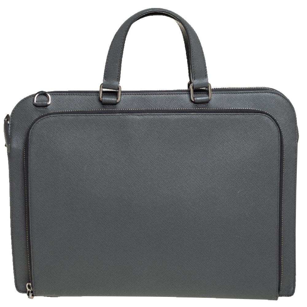 This Prada Travel briefcase brings such a fine shape that you're sure to look fashionable whenever you carry it. The men's briefcase has been crafted from grey Saffiano Lux leather and designed with two handles, zip compartments, and the Prada