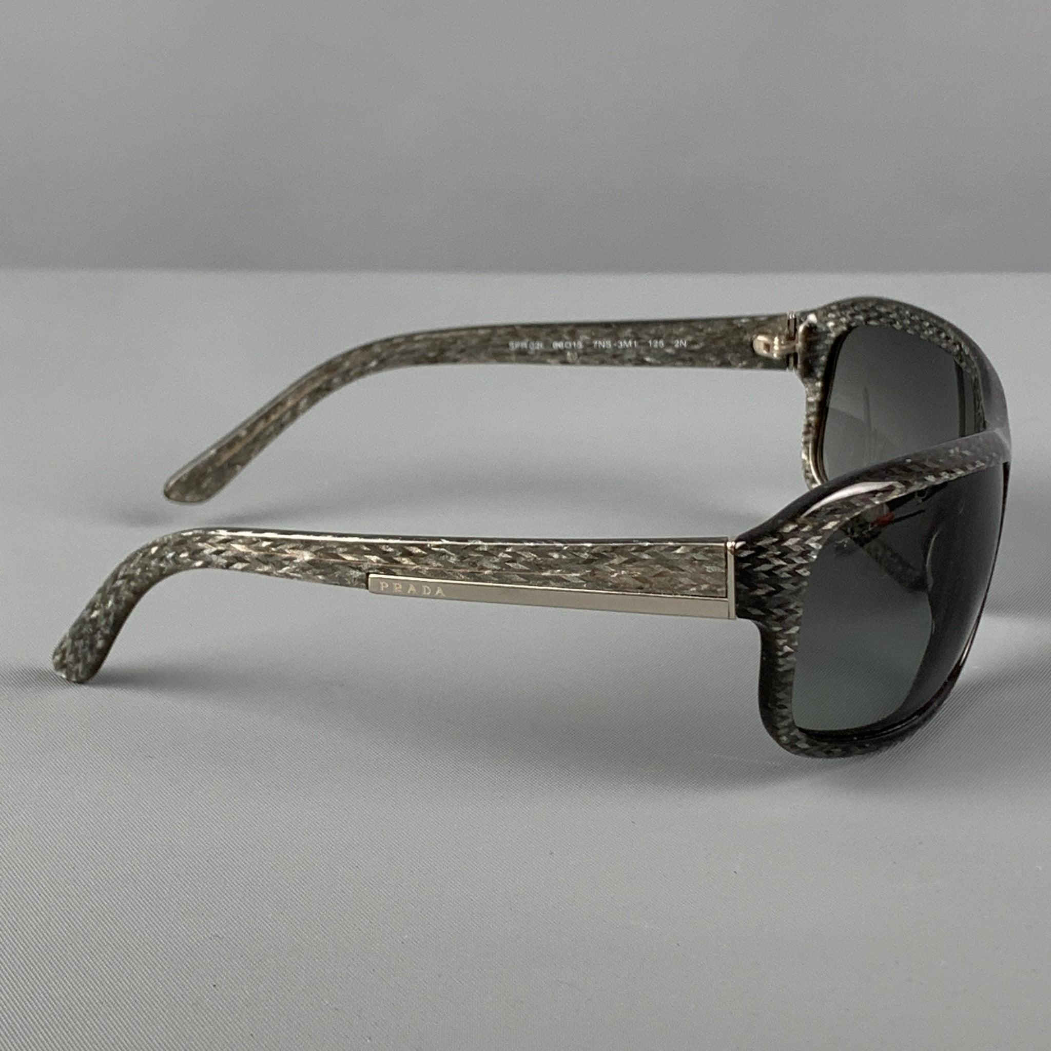 PRADA sunglasses comes in a grey shimmer acetate featuring tinted lenses and silver tone hardware. Made in Italy.
 Very Good
 Pre-Owned Condition. 
 

 Marked:  Spr02l 66-15 
 

 Measurements: 
  Length: 12 cm.Height: 4.75 cm.
  
  
  
 Sui Generis