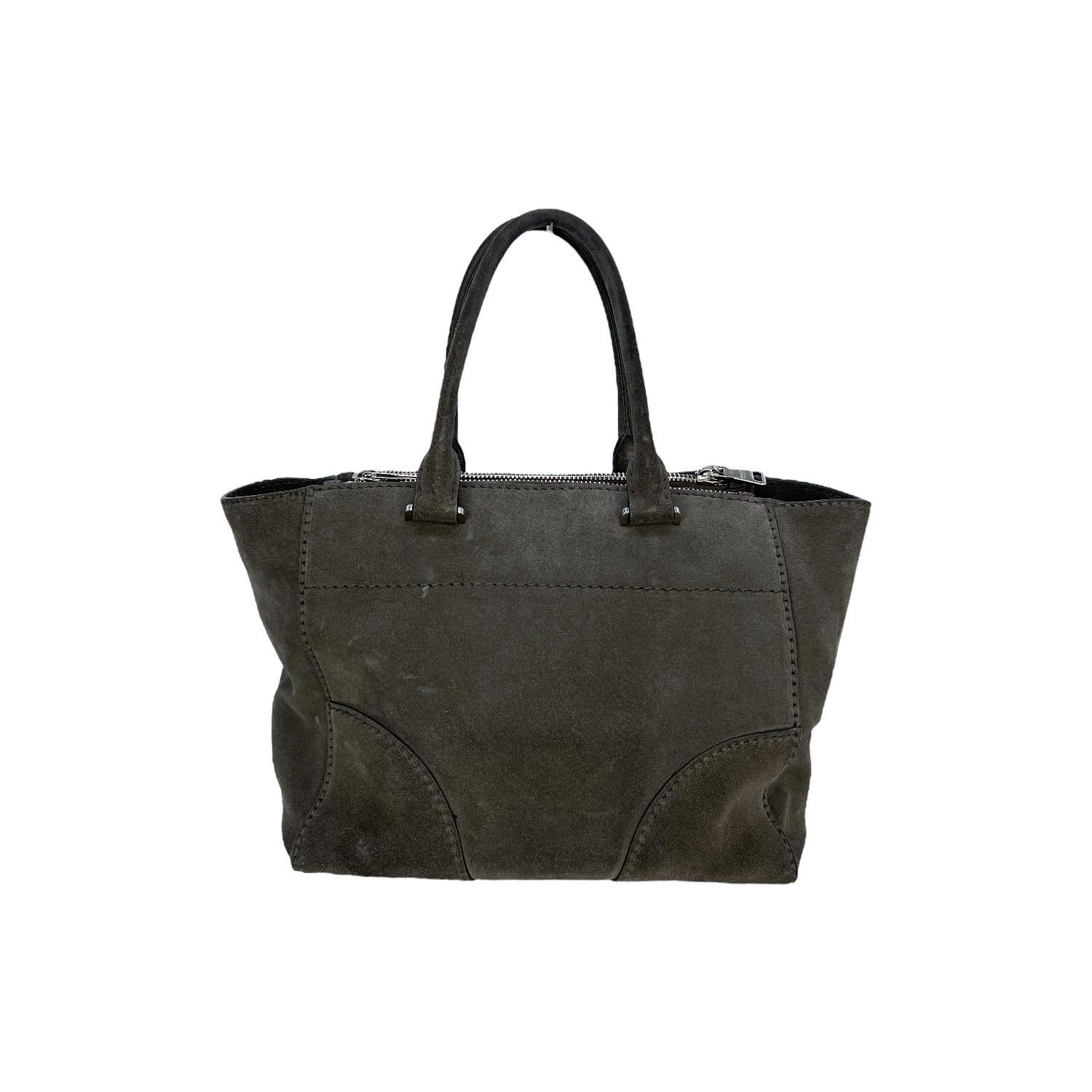 This Prada Twin Pocket Tote is finely crafted of a grey suede exterior with leather trimming and silver-tone hardware features. It has dual rolled top handles. It features twin zipper pockets on the front and backside that also includes a magnetic
