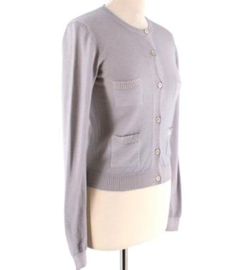 Prada Wool & Silk Blend Grey Cardigan

- Light weight material
- Warm blend of wool perfect for layering up 
- Mini open pockets (X4) on the breast and lower body
- Ribbed detail on the collar & hemline
- Hip length
- Semi-glossy tortoise shell