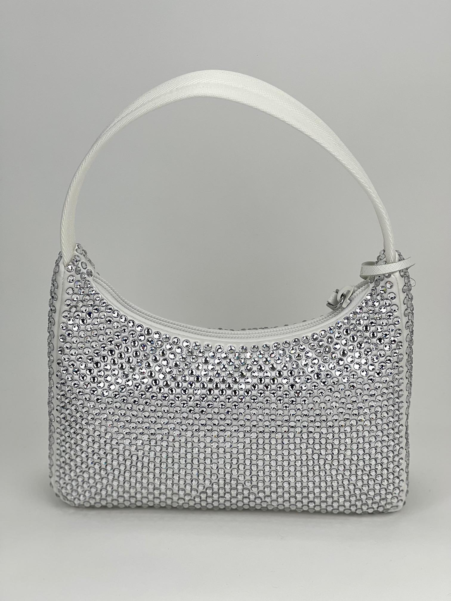 PRADA Re Edition 2000 White Satin
Mini-Bag with Crystals
NEW 100% AUTHENTIC
CONDITION: New
COLOR: white 
CODE: 1NE515
MATERIAL: satin, canvas, artificial crystals
HANDLE: single white canvas
DROP: 6.25
MEASUREMENTS: H 6.5