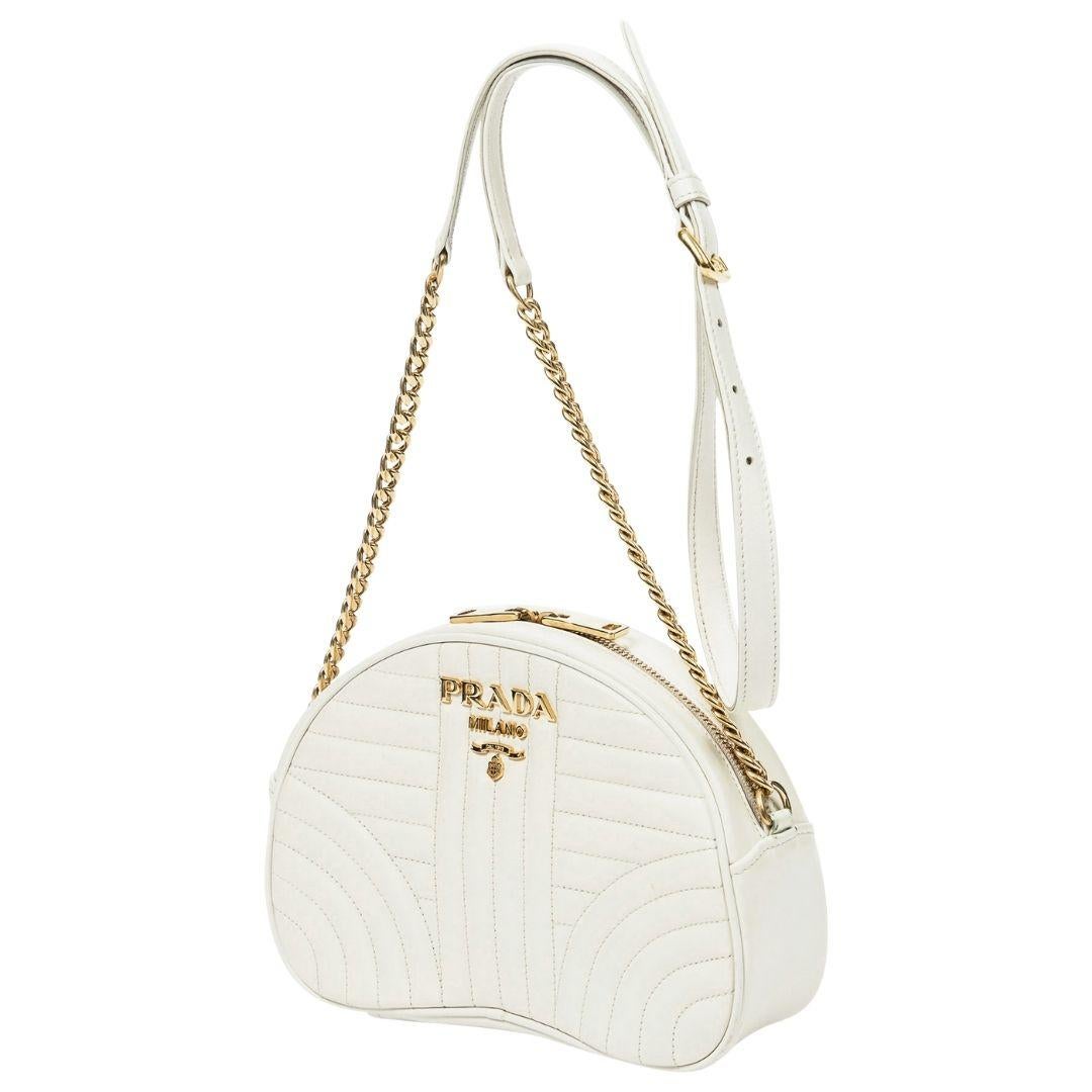 An elegant ivory Diagramme leather crossbody with gold hardware and a zipper closure. Inside, the logo jacquard lining includes one slip pocket, perfect for minimal carry.

SPECIFICS
Length: 8.7
Width: 2.8
Height: 5.9
Strap drop: 23
Authenticity