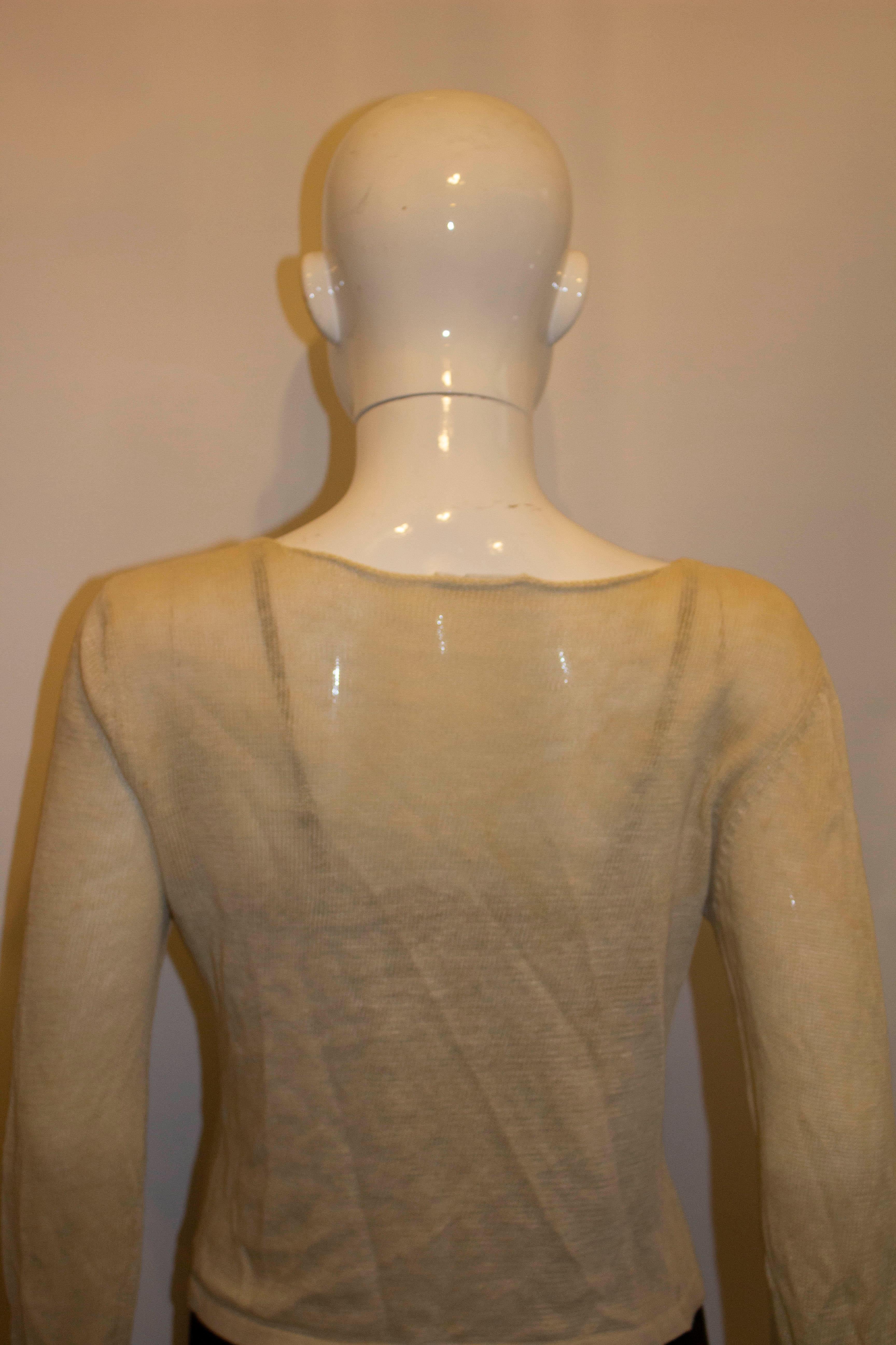 A chic and easy to wear summer knit by Prada. The top is knitted linen in an ivory colour . Made in Italy. 
Size 40  Bust 37'', length 20''