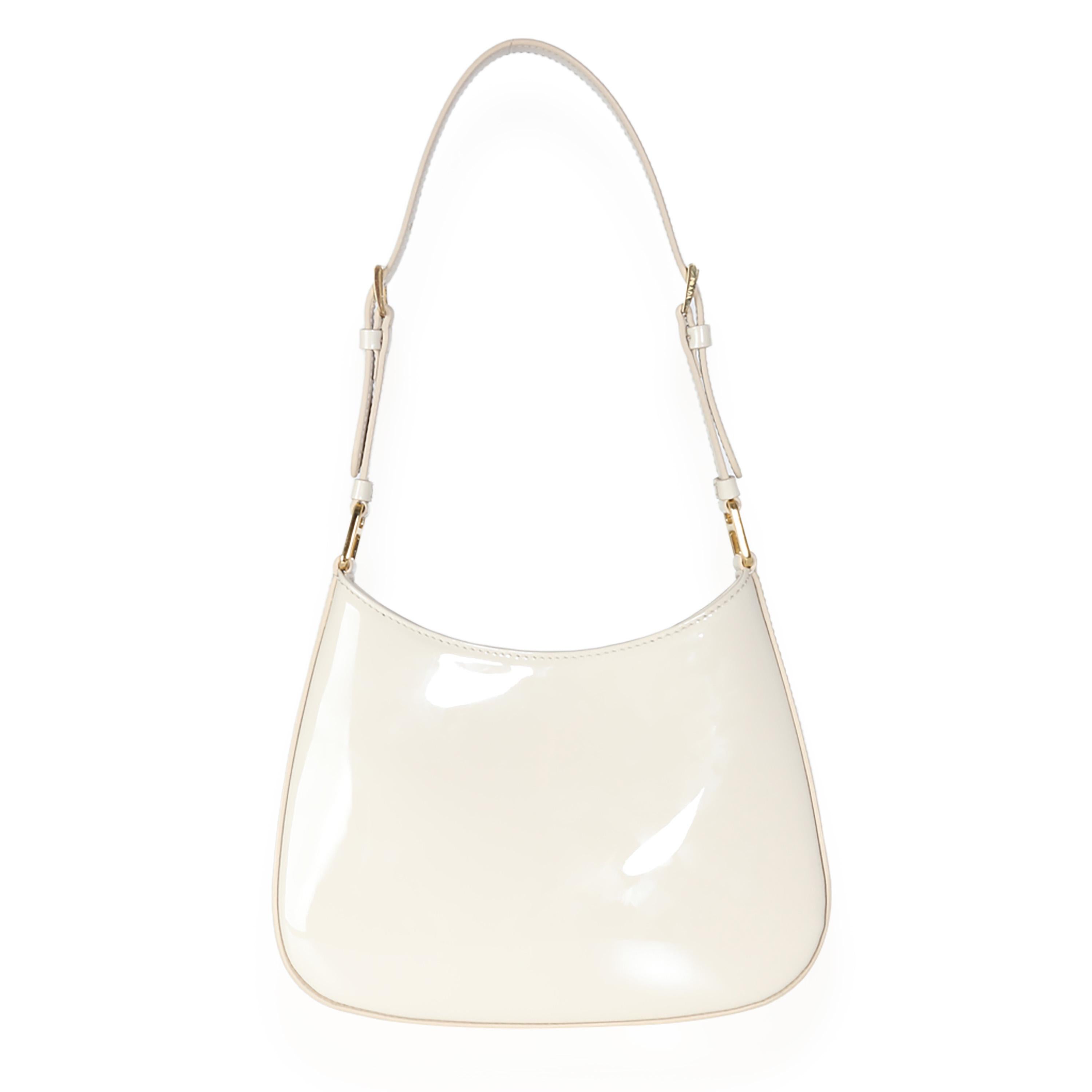 Listing Title: Prada Ivory Patent Cleo Bag
SKU: 140243
MSRP: 2850.00 USD
Condition: Pre-owned 
Condition Description: Reimagining a classic design from the ‘90s, the Cleo bag from Prada epitomizes pared-back luxury. Soft curved lines and a