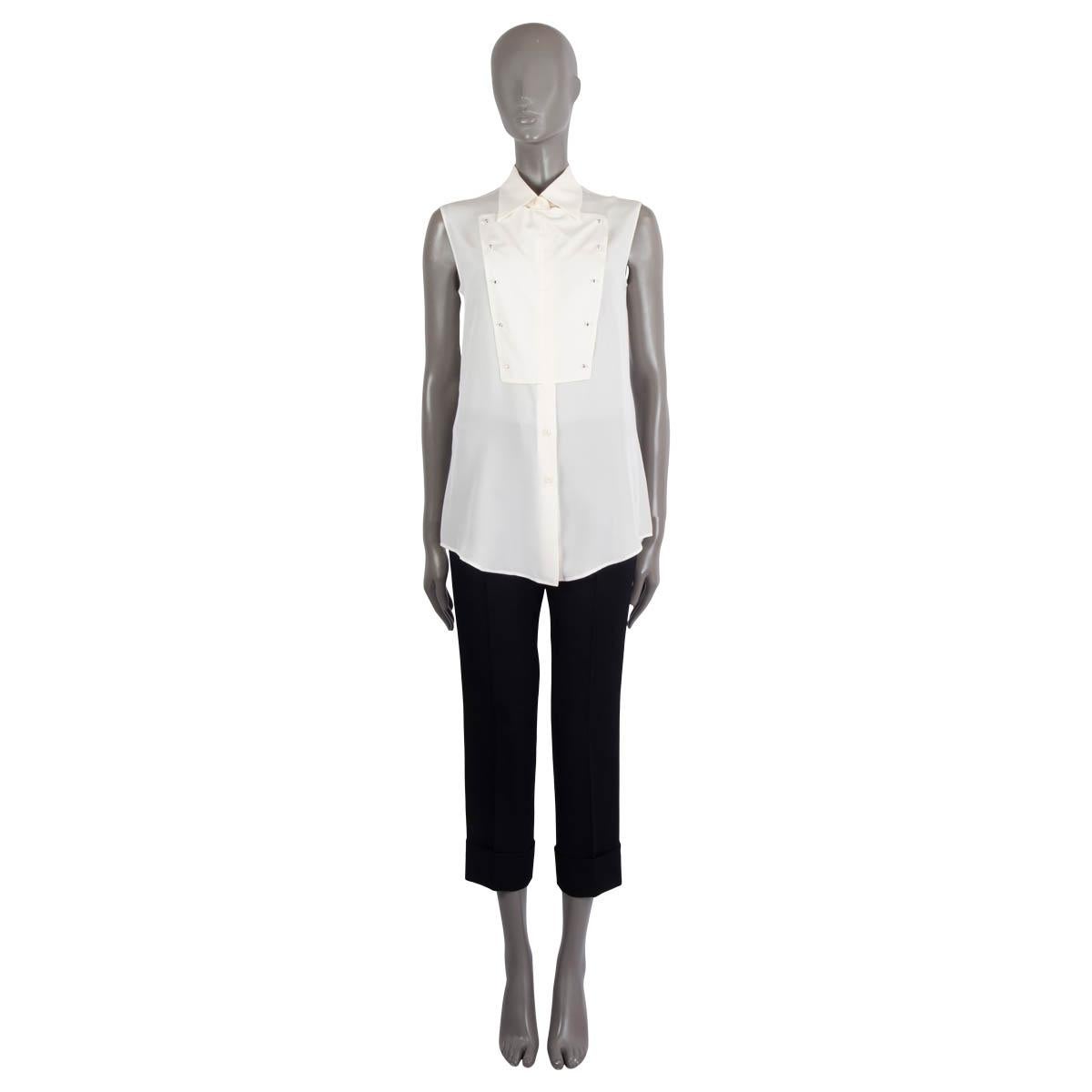 100% authentic Prada 2016 bib front sleeveless crepe silk (100%) (missing tag) shirt in ivory. Has been worn and is in excellent condition. 

Measurements
Tag Size	Missing
Size	S
Shoulder Width	37cm (14.4in)
Bust From	94cm (36.7in)
Waist From	92cm