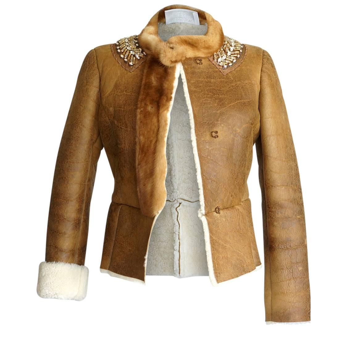 Mightychic offers a Prada superb distressed shearling jacket.      
Shearling accentuated with mink mandarin collar and front trim.
Fabulous diamante and beading around collar.
Front mink placket creates hidden hook and eye closures.
Sleeves can be