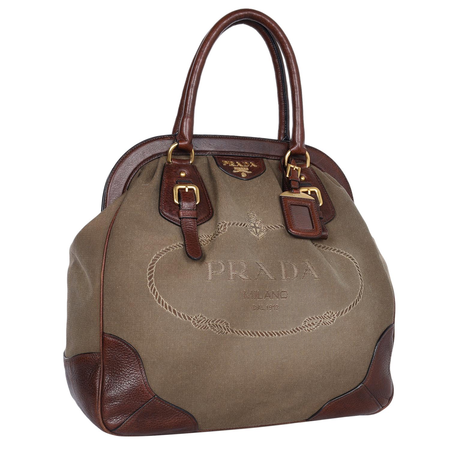 Authentic, pre-loved Prada brown canvas and leather shoulder bag. The refined look and durable construction define this smart Prada shoulder bag that can be your ideal pick for any season. Features leather rolled handles, canvas, and leather