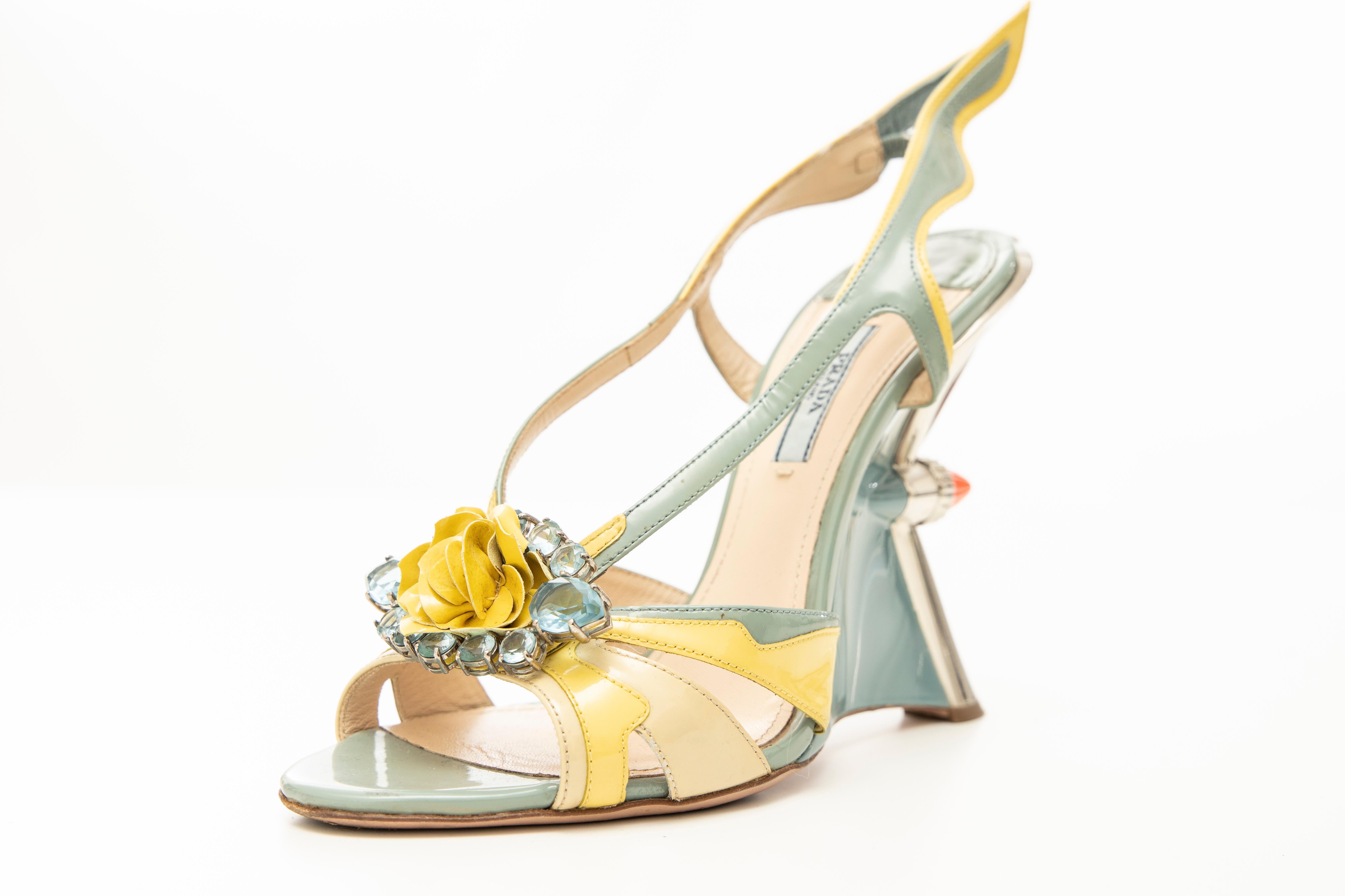 Prada, Spring-Summer 2012 jewel silver-tone taillight wedge sandal with flame accents at sides, floral appliqué at tops featuring crystal embellishments, resin heels with elasticized slingback straps. Includes dust bag.

IT. 40, US. 10

Heels: 5.25