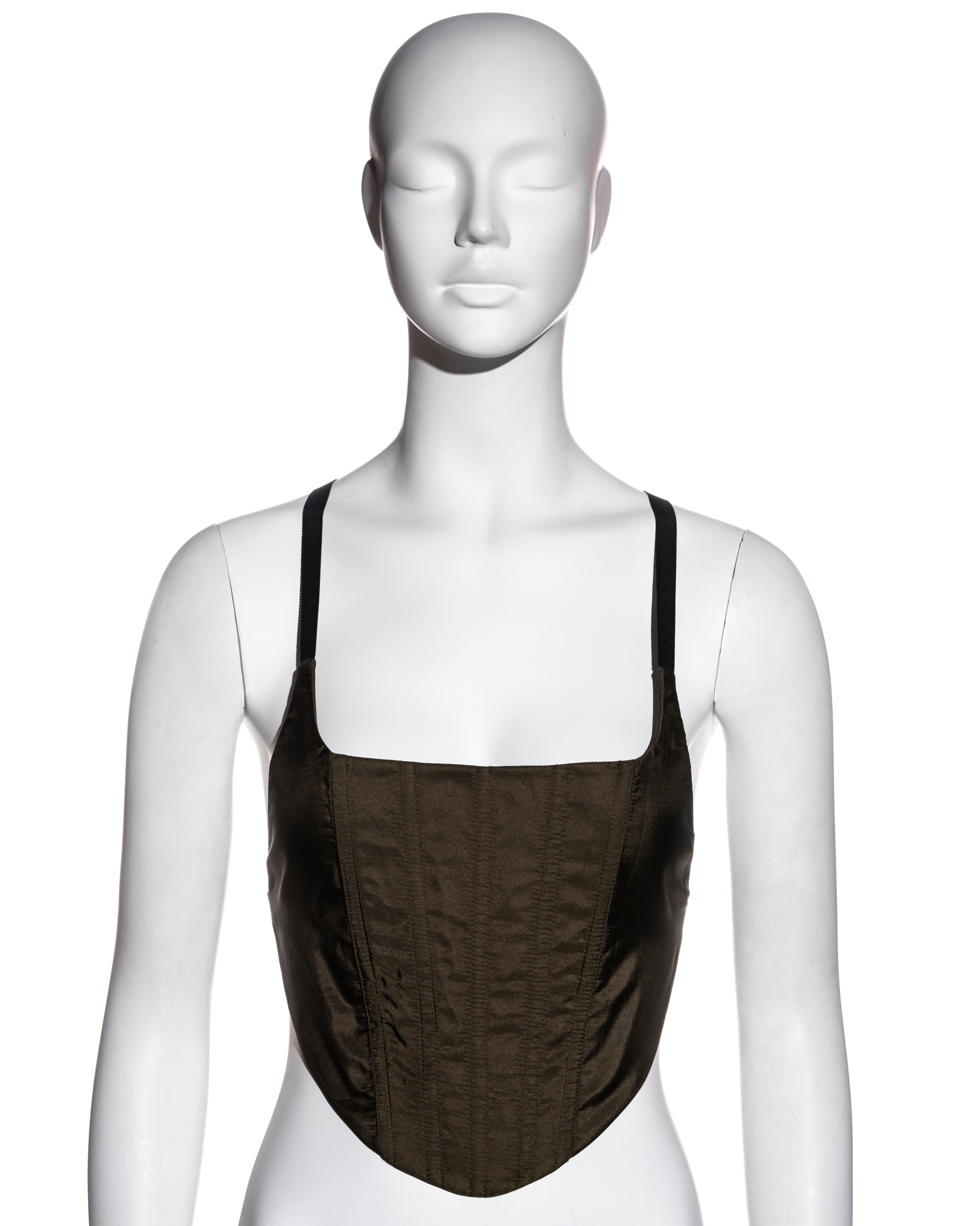 ▪ Prada khaki green silk corset top
▪ Designed by Miuccia Prada
▪ Boned bodice 
▪ Black grosgrain straps 
▪ Logo etched metal buckles at sides 
▪ Adjustable velcro fastenings at back 
▪ IT 40 - FR 36 - UK 8 (sizing is slightly flexible due to velcro