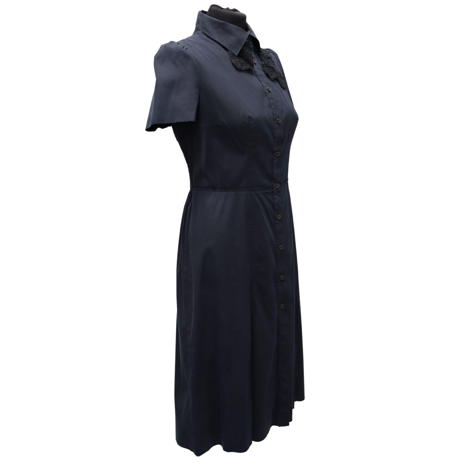 Prada collared knee length shirt dress with floral appliqués at the shoulders. Stretch/elastic panel at the back for a more comfortable fit. Button up closure.

Tag Size: 46 (fits more like a US8)

Measurements: (Approx)
Shoulder 36cm
Bust