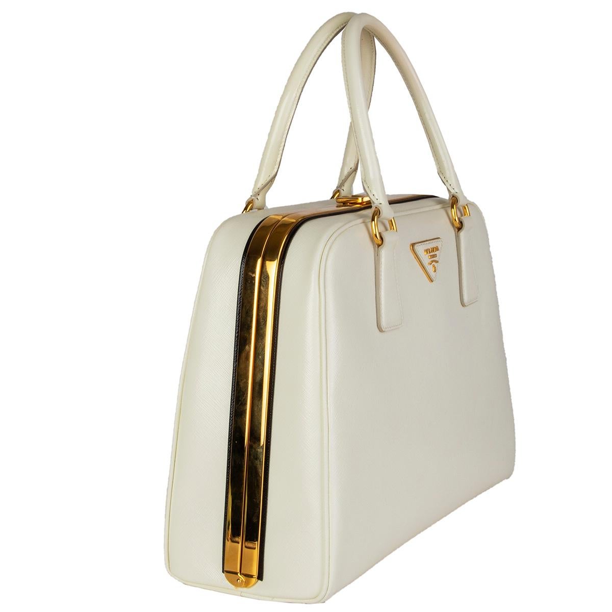 Prada 'Larice BL808F' handbag in ivory  Saffiano Vernic leather with black trim featuring gold-tone hardware. Opens with a spring hinge closure frame top. The interior is lined in nude smooth leather with two large zip pockets and three open