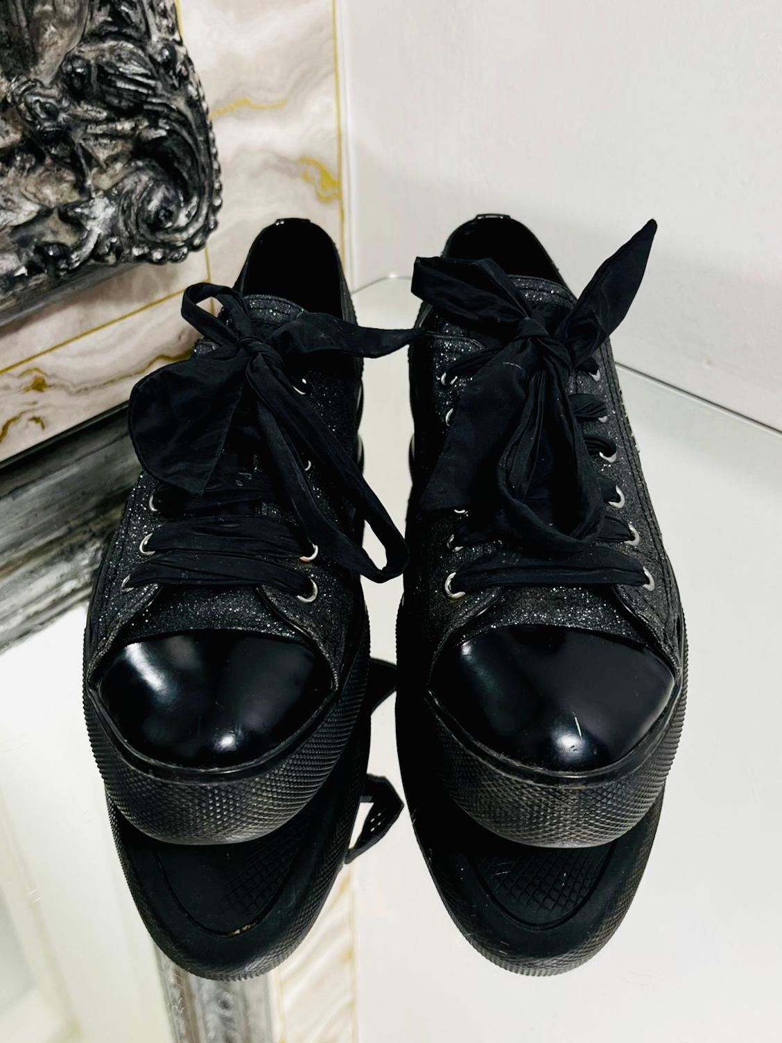 Prada Leather Glitter Sneakers

Black leather with glitter finish through out, with patent leather toe caps and heels.

Silver metal logo to each side and finished with ribbon laces. Rubber logo soles.

Size - 38

Condition - Good (A mark to one