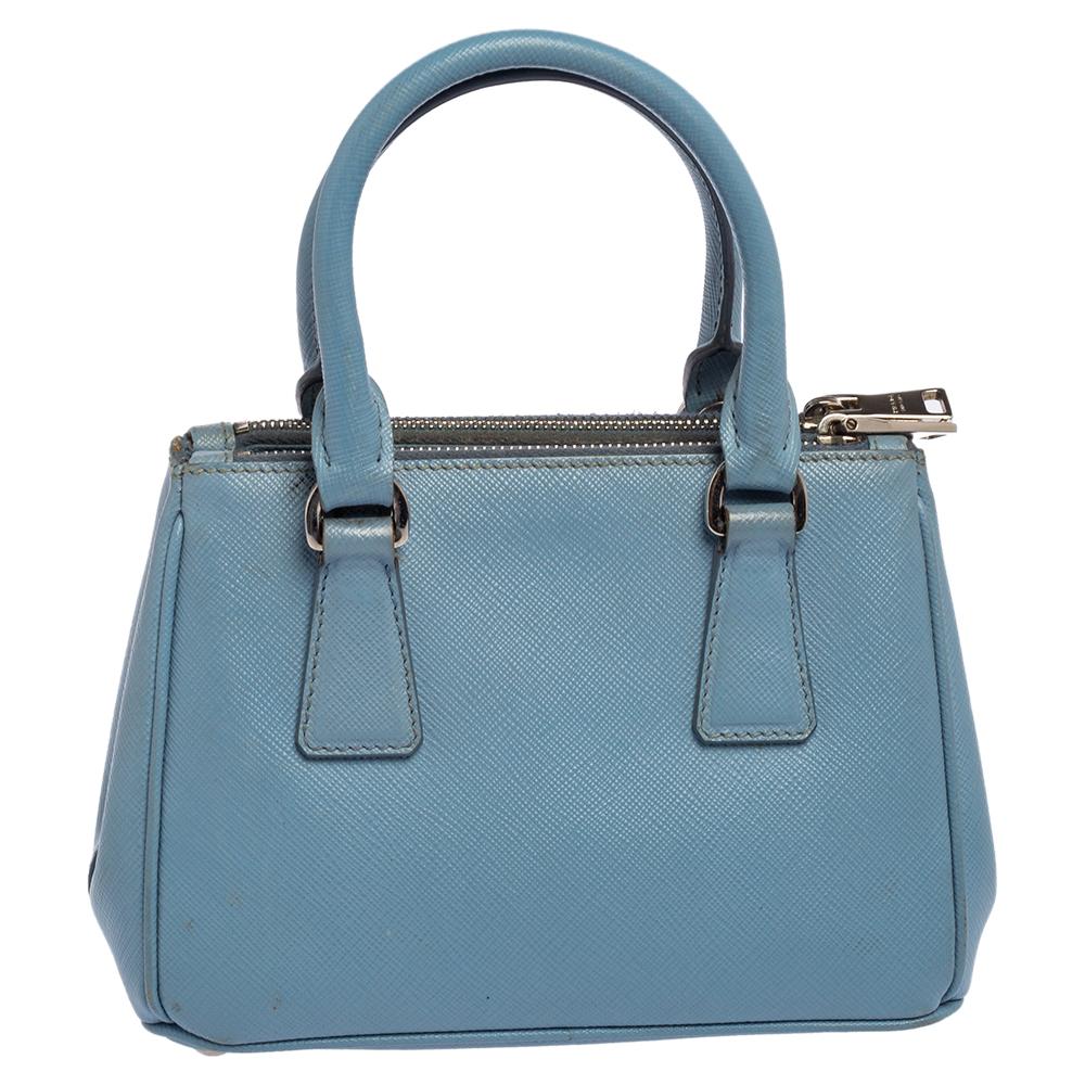 Loved for its classic appeal and functional design, Galleria is one of the most iconic and popular bags from the house of Prada. This beauty in light blue is crafted from Saffiano leather and is equipped with two top handles, the brand logo at the