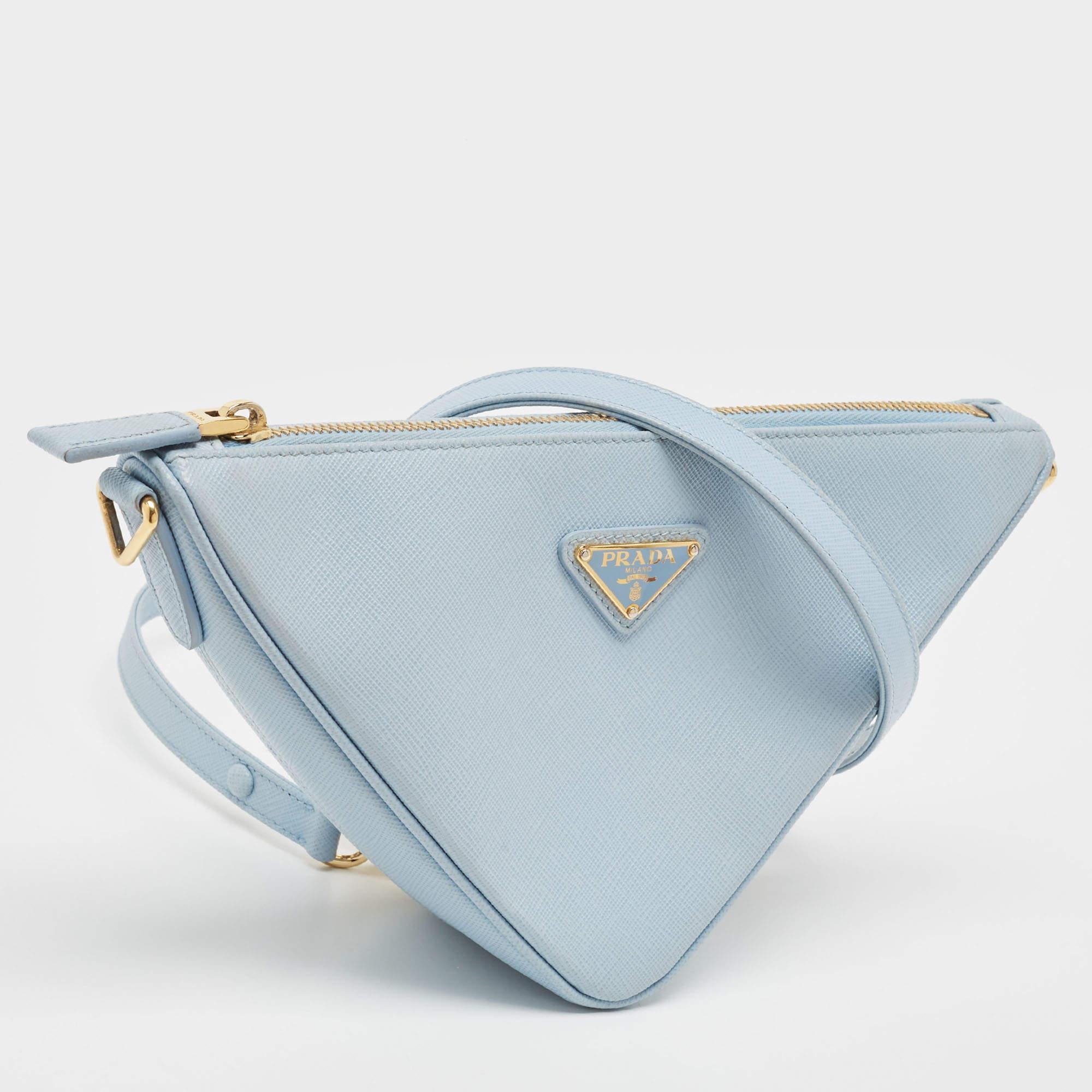 This stunning triangle bag by Prada has been crafted to instantly elevate your look. Made of leather in light blue, this bag has a luxe exterior with the brand accent on the front. It has a detachable strap.


