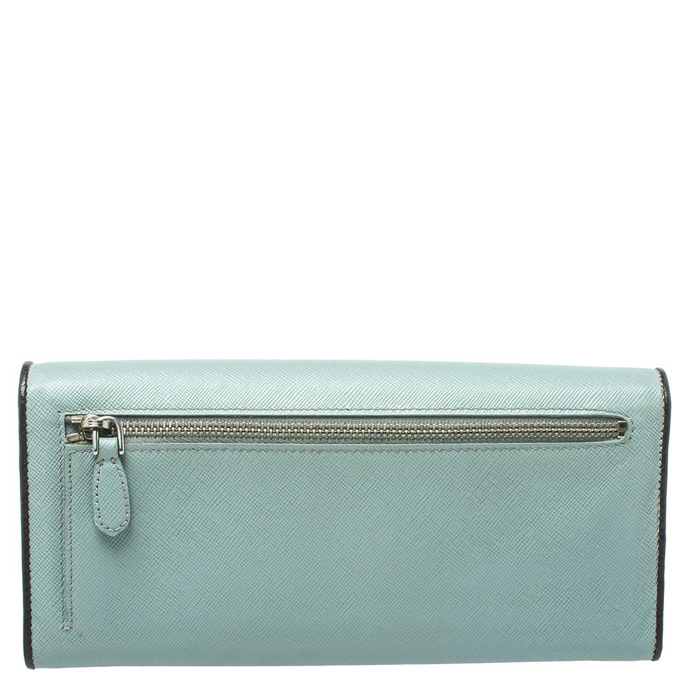 Indulge in a feel of luxury with this Prada continental wallet in light blue. This stylish piece is made of high-quality leather and features a turn lock on the front flap. The beauty houses multiple card slots and a zip compartment to neatly
