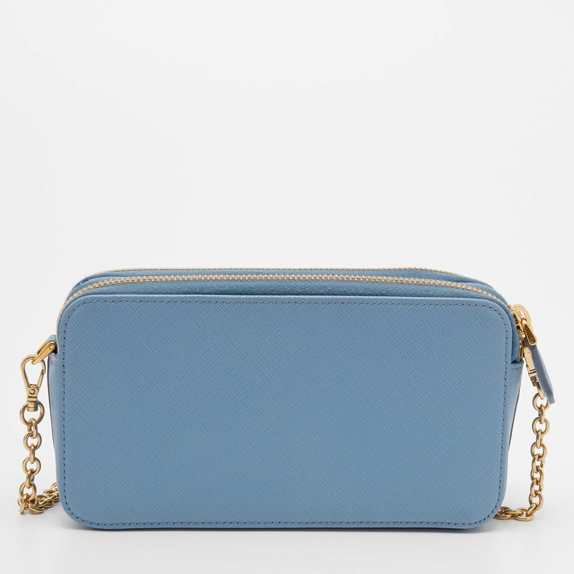 Carry this versatile Prada crossbody bag with you wherever you go! Made using light blue Saffiano leather, it has a compact shape and comes with a long chain strap. Style the lovely bag with any summer outfit!

Includes: Original Box