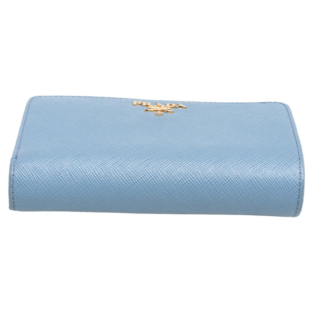 Keep it classy with this compact wallet from the house of Prada. It has been designed from Saffiano leather and carries a lovely shade of light blue. It has the brand logo in the front and a leather & nylon interior with multiple slots to organize