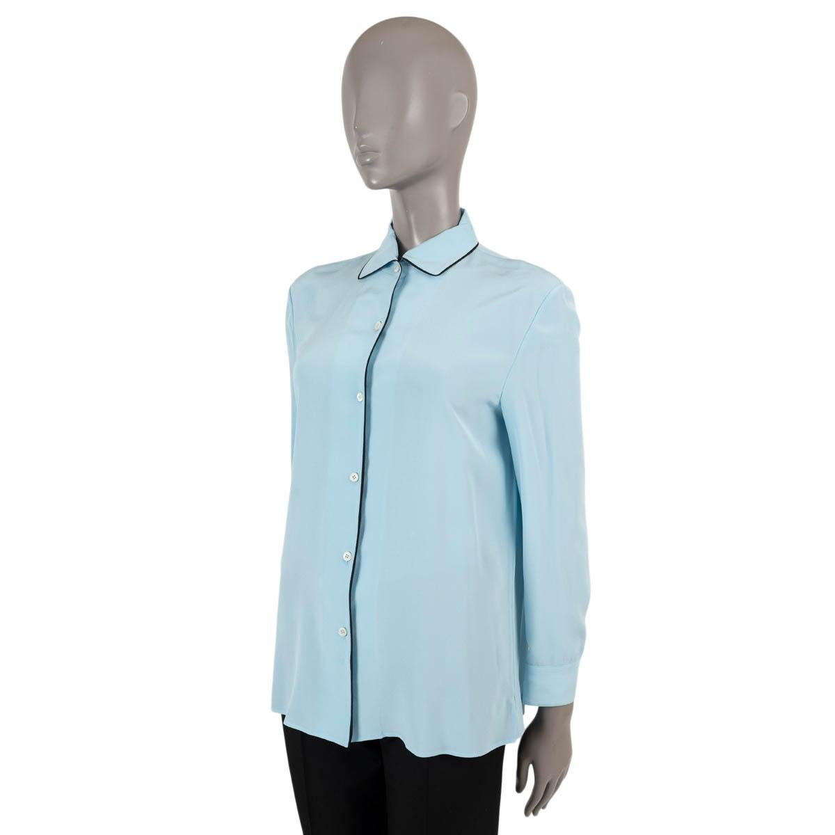 100% authentic Prada Classic blouse in light blue silk (100%) with black trim. Opens with buttons on the front. Unlined. Has been worn and is in excellent condition.

Measurements
Tag Size	40
Size	S
Shoulder Width	43cm (16.8in)
Bust From	100cm