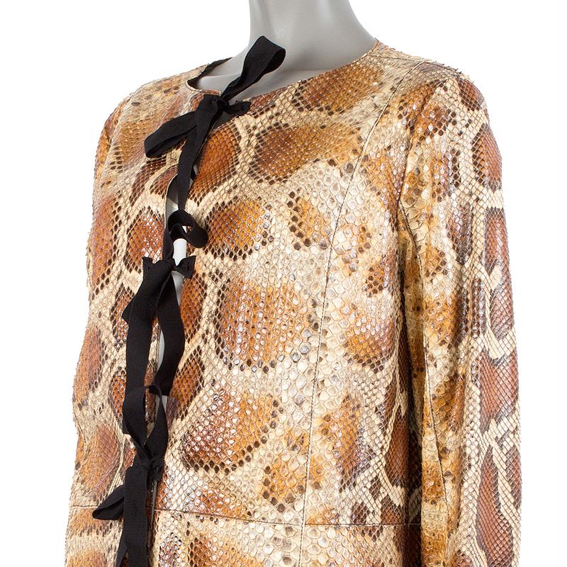 100% authentic Prada long collarless coat in dark brown, brown, tan, and beige python, with two front slit pockets. Closes with three bow-straps on the front. Unlined. Has been worn and is in excellent condition.

Measurements
Tag