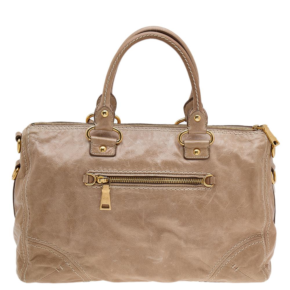 Spacious, durable, stylish — Prada's shopper tote is a fine example of what an everyday bag should be. This designer tote is crafted from light brown leather and comes with two handles, an optional strap, and a fabric interior.

Includes: Strap